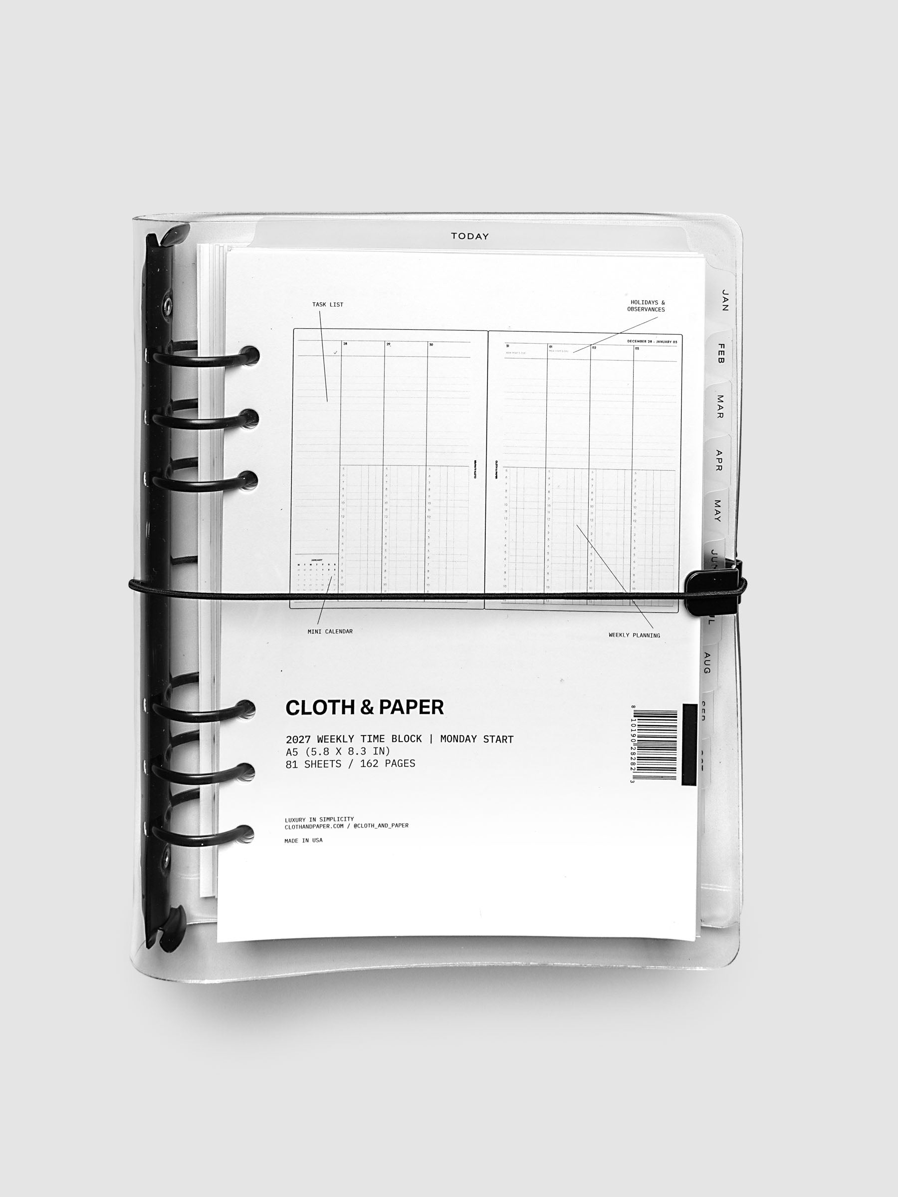 Closed clear vinyl planner cover with black 6-ring binding and a black elastic closure, front page displaying a labeled weekly time block spread with task list, holidays and observances, mini calendar, and weekly planning callouts, A5 6-Ring Punch size