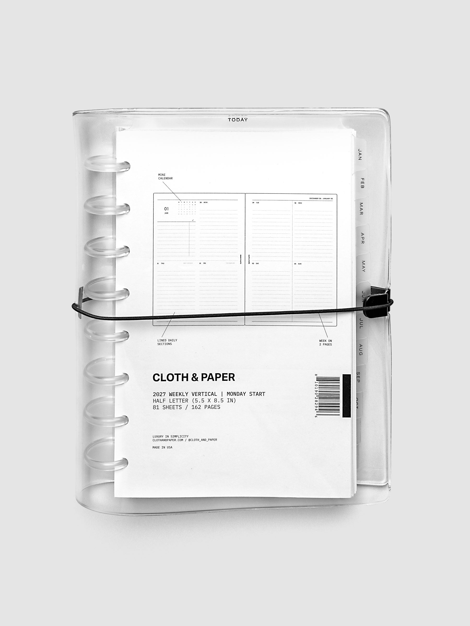 Closed clear vinyl planner cover with clear 8-disc binding and a black elastic closure, front page displaying a labeled weekly vertical spread with mini calendar, lined daily sections, and week on two pages callouts, Half Letter 8-Disc Punch size