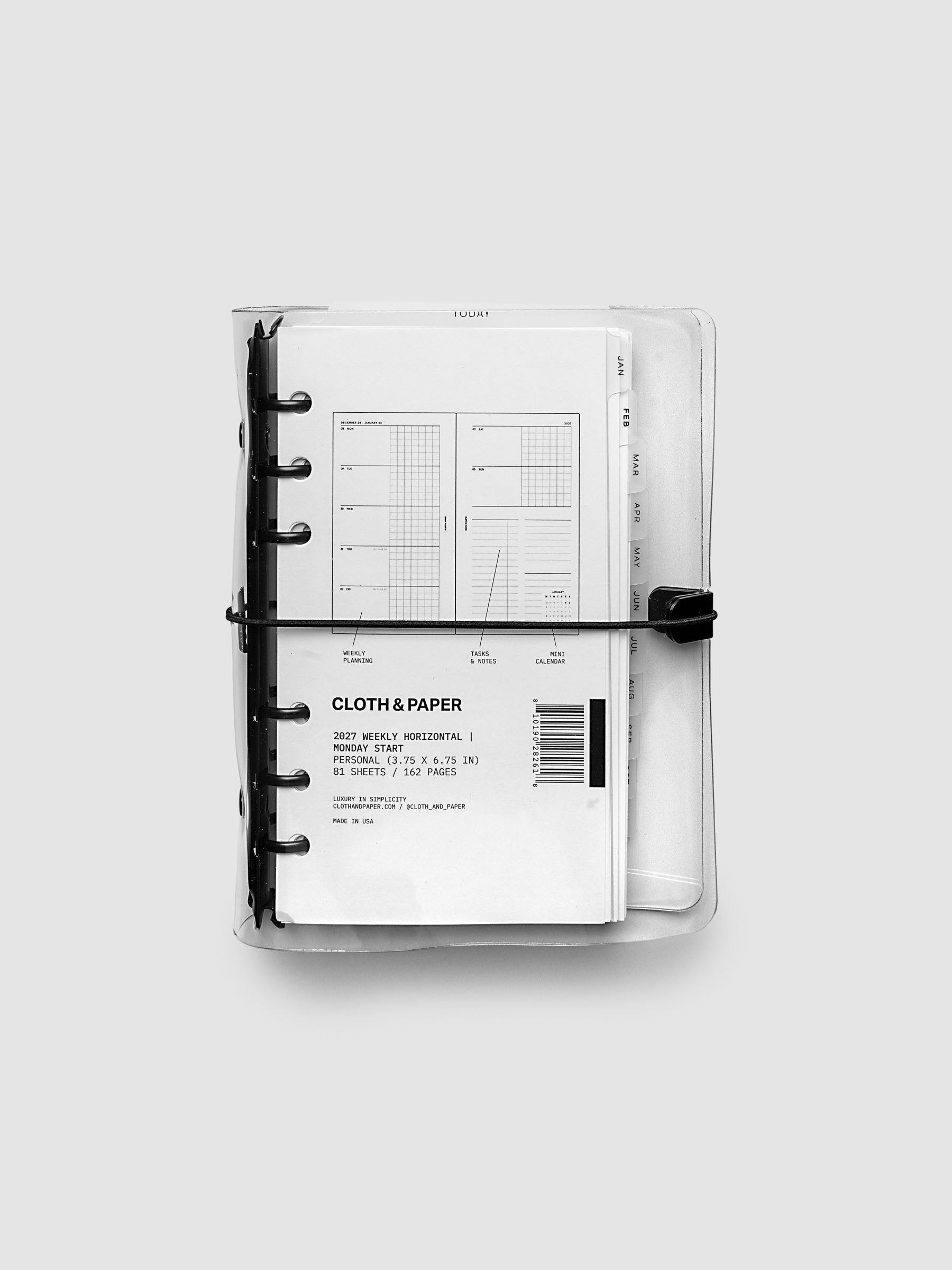 Closed clear vinyl planner cover with black 6-ring binding and a black elastic closure, front page displaying a labeled weekly horizontal spread with weekly planning, tasks and notes, and mini calendar callouts, Personal 6-Ring Punch size