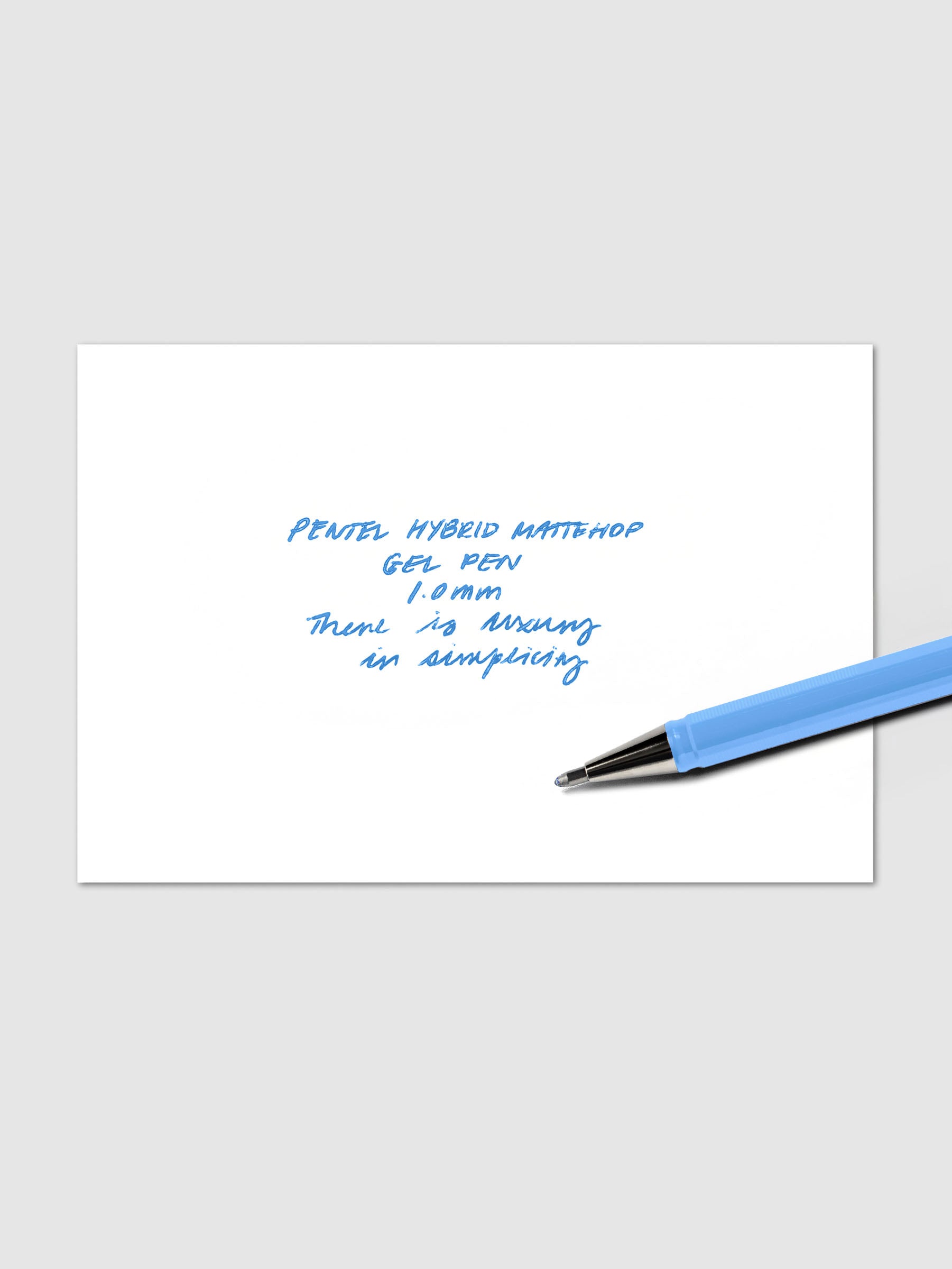 Light Blue Pentel Mattehop Hybrid Gel Roller Pen with 1.0 mm nib shown at an angle on top of handwritten writing sample.
