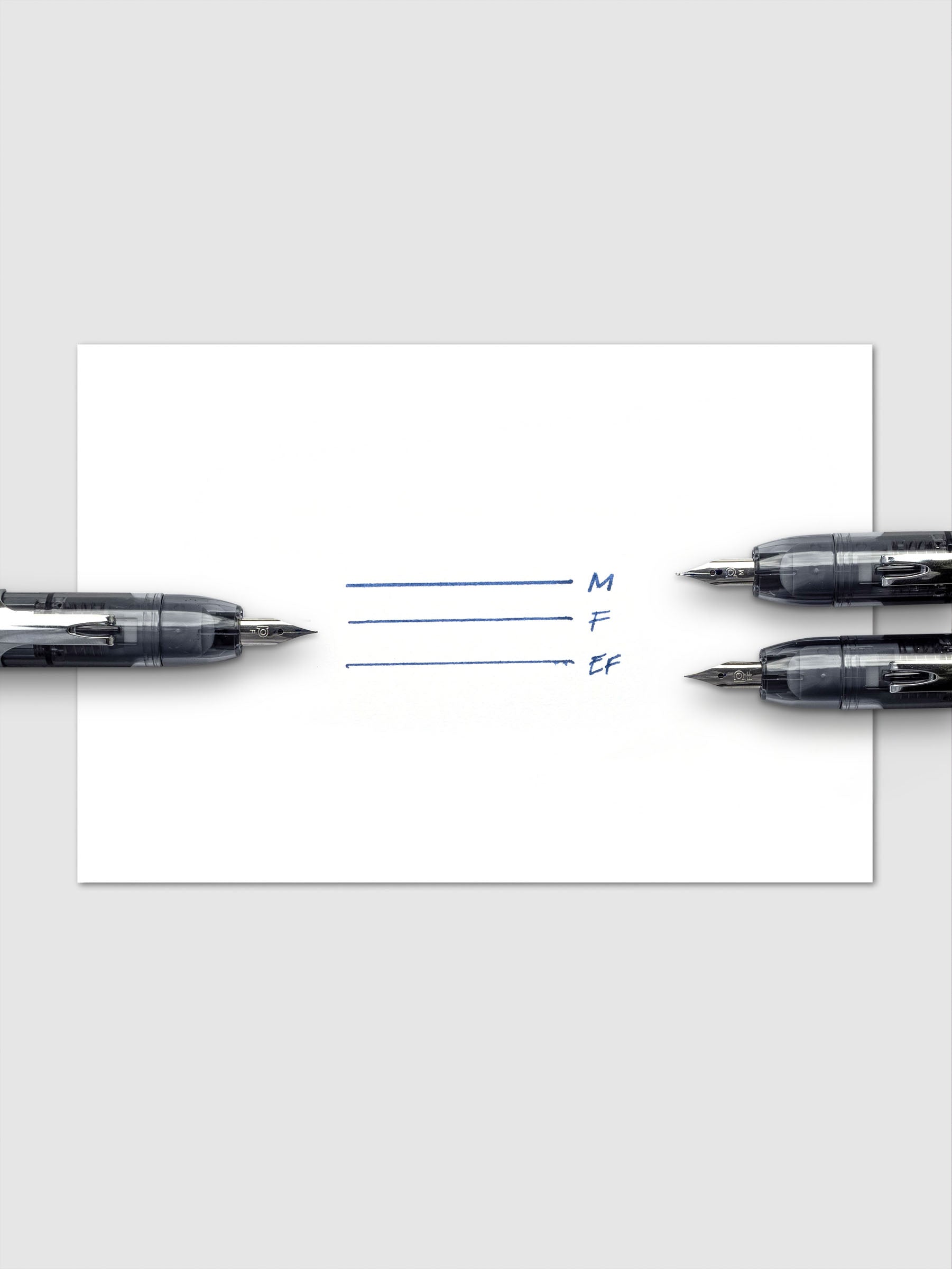 Handwritten lines displaying line thickness in medium, fine, and extra fine nibs.