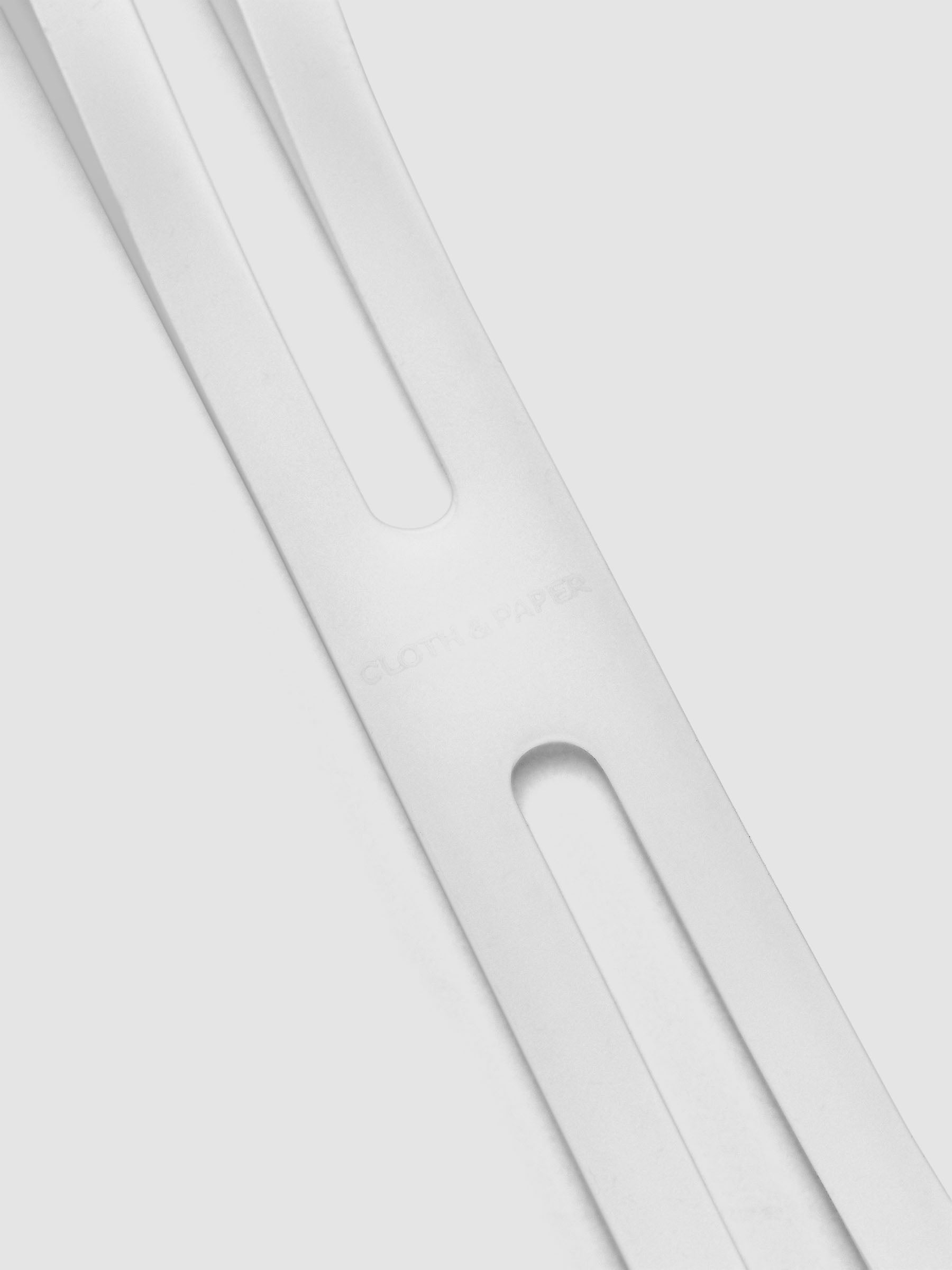 Detail view of Cloth & Paper logo on the large, clear planner closure band.