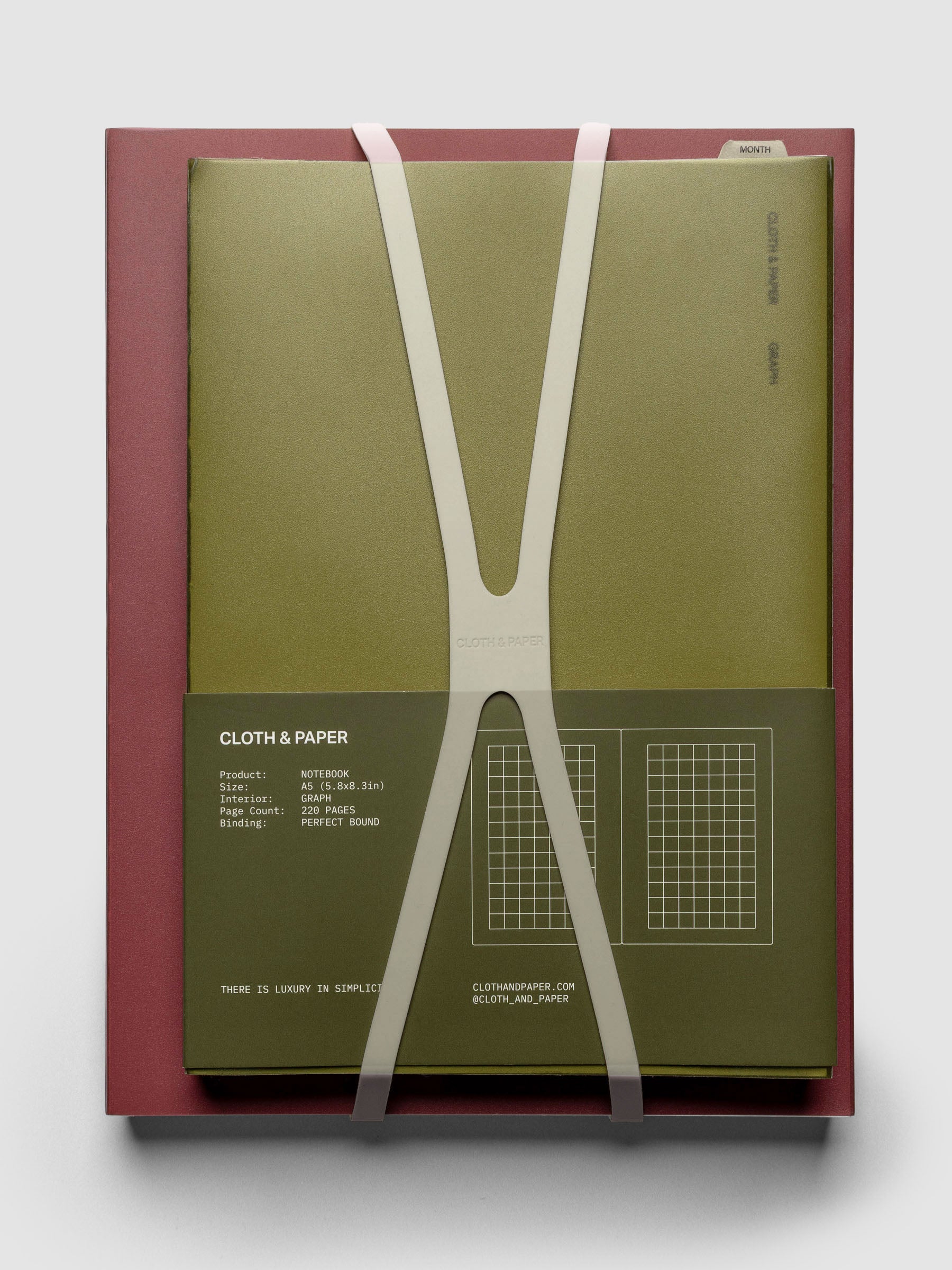 Large, clear planner closure band shown in use with an HP Classic and A5 perfect bound notebook stacked.