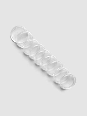 Set of 9 clear, transparent 1 inch planner discs laying diagonal on a grey background.