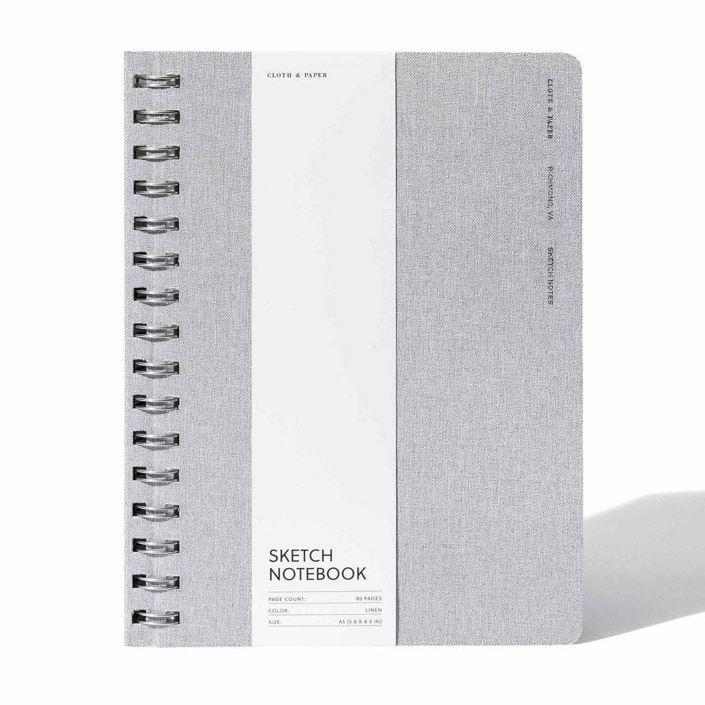 Linen notebook displayed with its packaging on a white background.