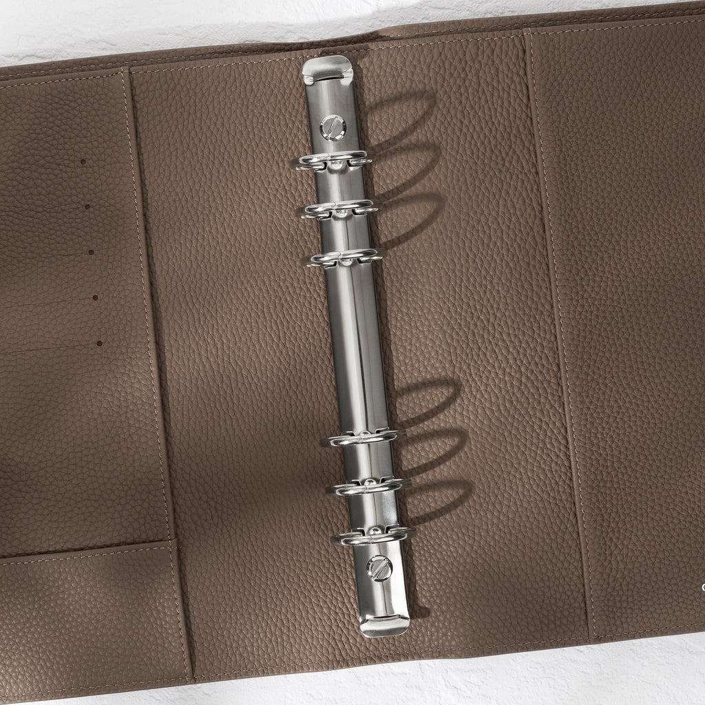 Closeup of silver hardware in a cortado leather agenda.