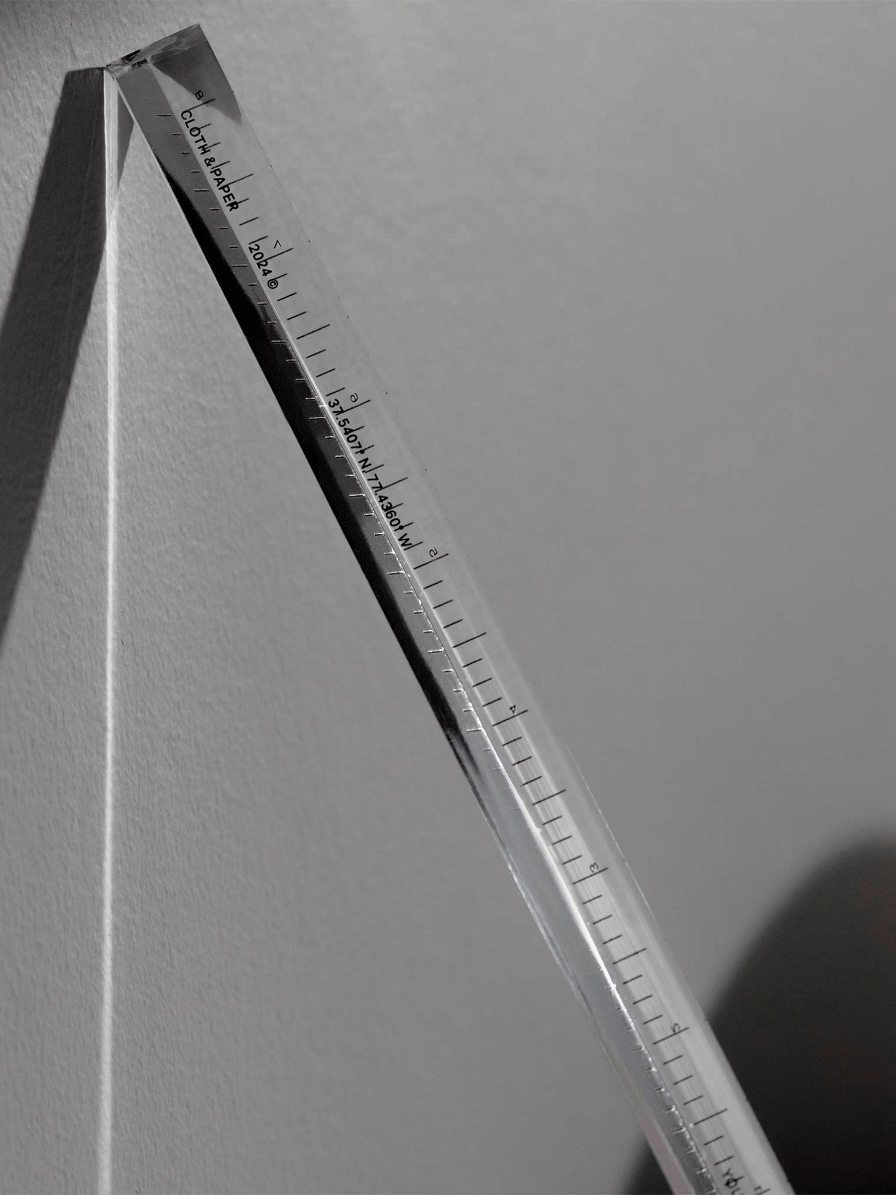 Close up of ruler that reads "Cloth & Paper | 2024"