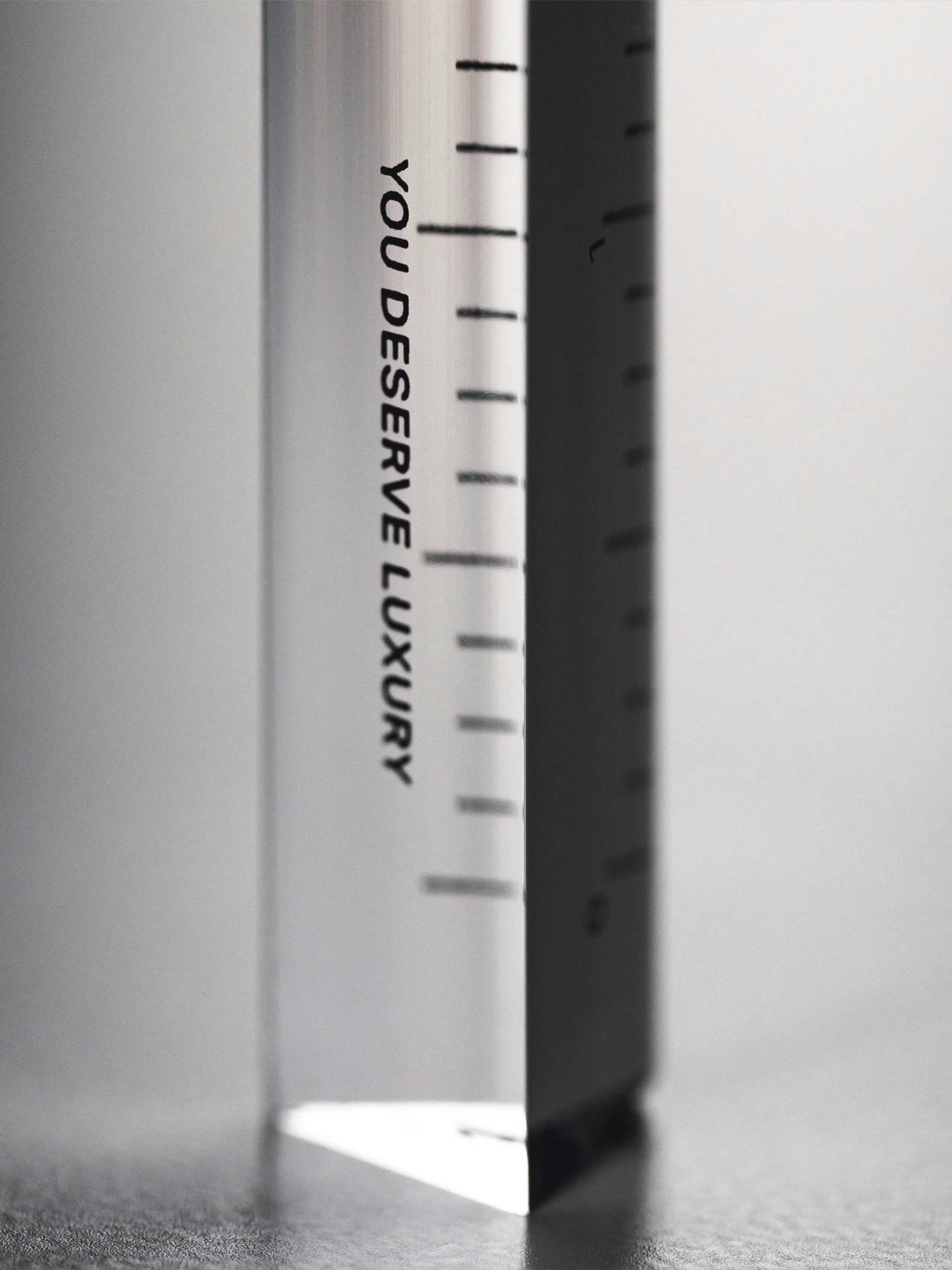 Close up of text on ruler that reads "YOU DESERVE LUXURY."