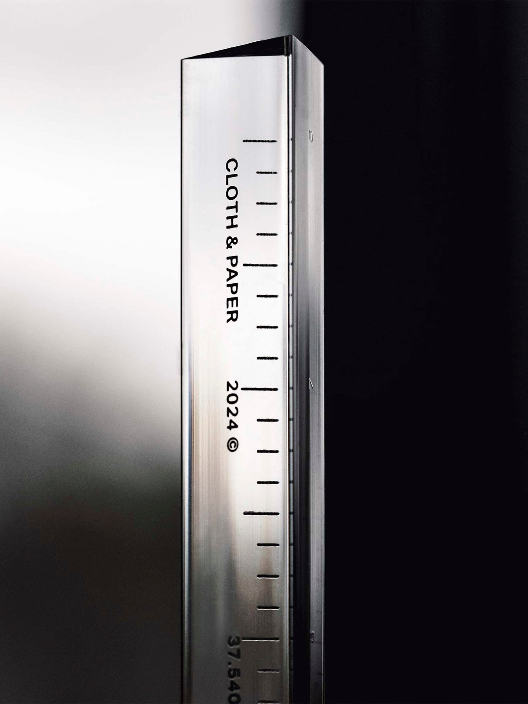 Close up of ruler that reads "Cloth & Paper | 2024"