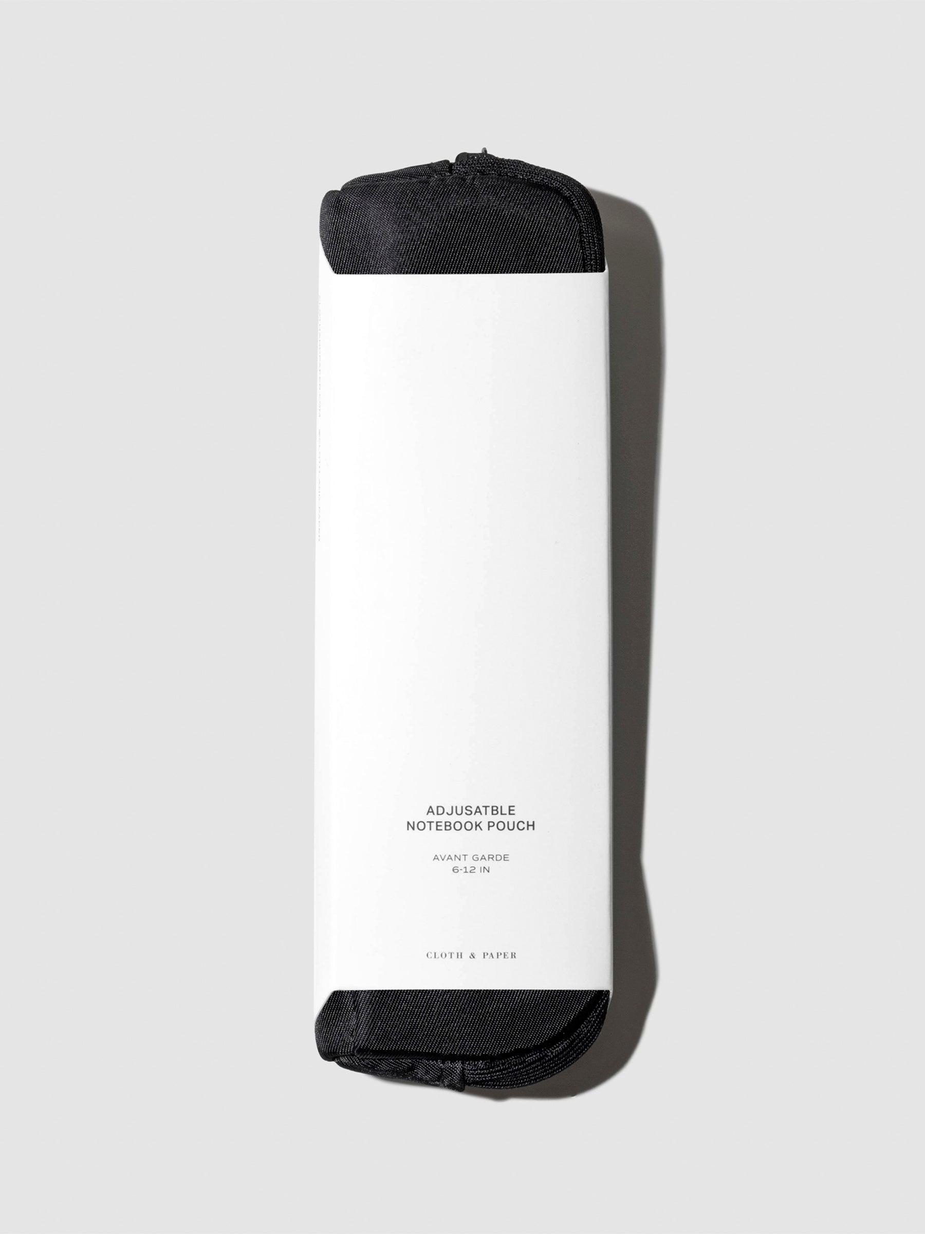 Notebook pouch displayed with its packaging on a neutral background. Color shown is Avant Garde.