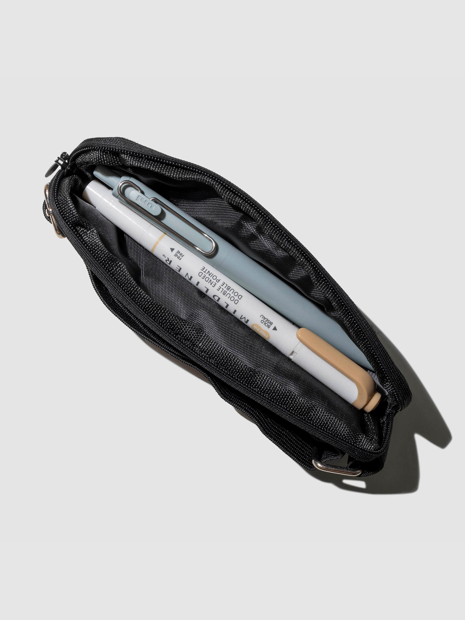 A marker and highlighter shown stored inside a notebook pouch. Color shown is Avant Garde.