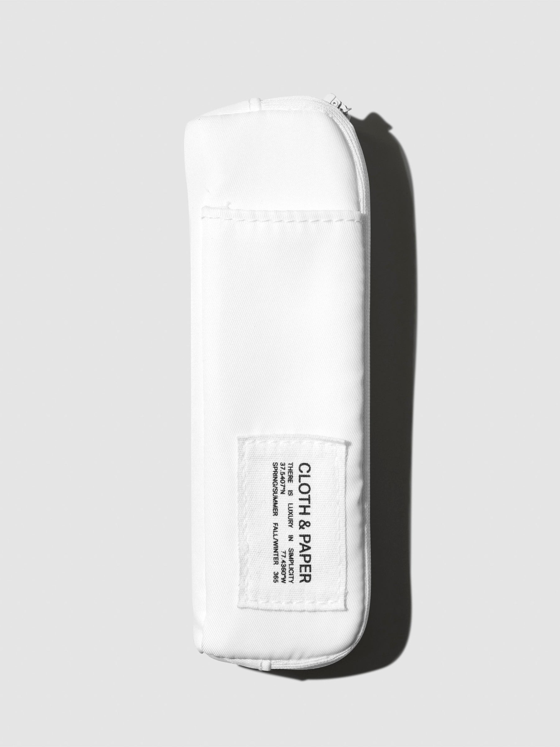 Adjustable Notebook Pouch, Cloth and Paper. Notebook pouch displayed with its packaging on a neutral background. Color shown is Le Blanc.