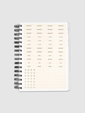 Planner Stickers in a 2022 Spiral Bound Planner on a neutral background