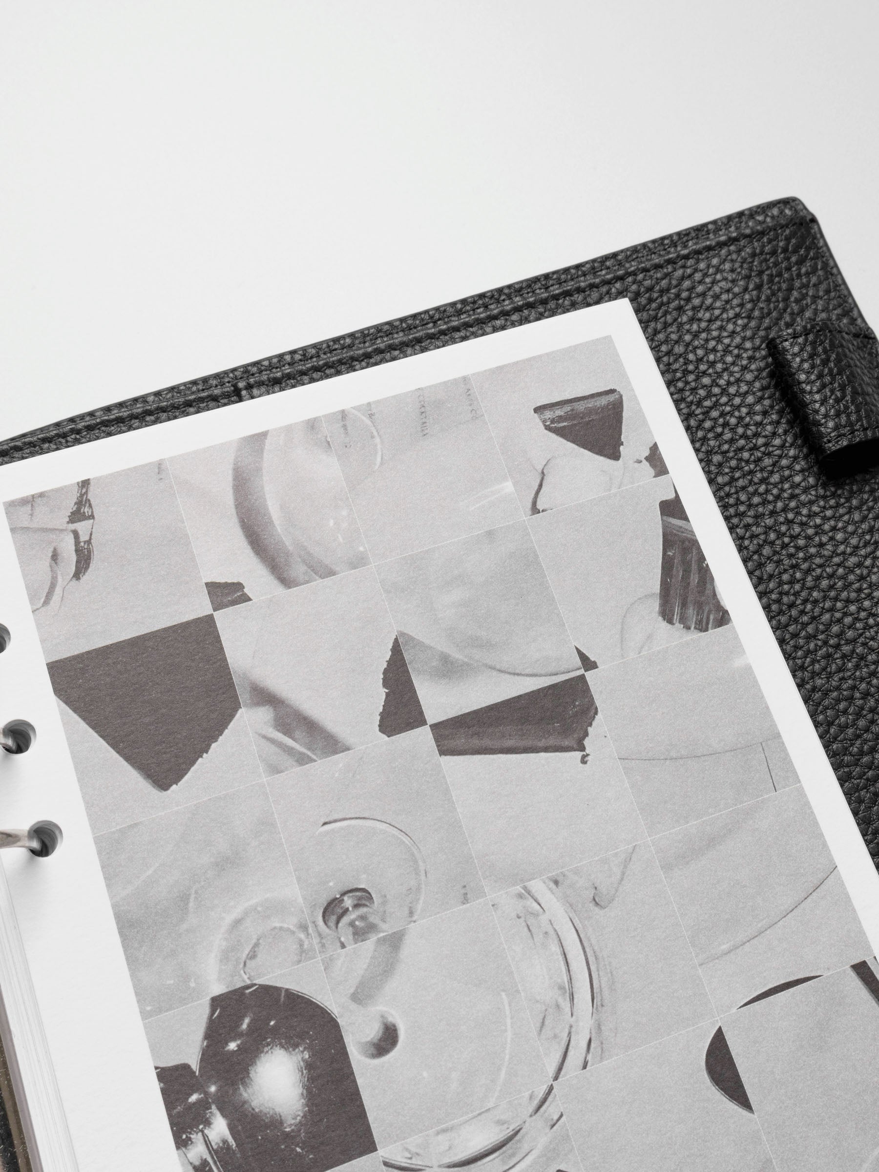 A close-up view of the Ambiance Planner Dashboard trio, showcasing a monochromatic collage of abstract images, including glassware and geometric shapes.