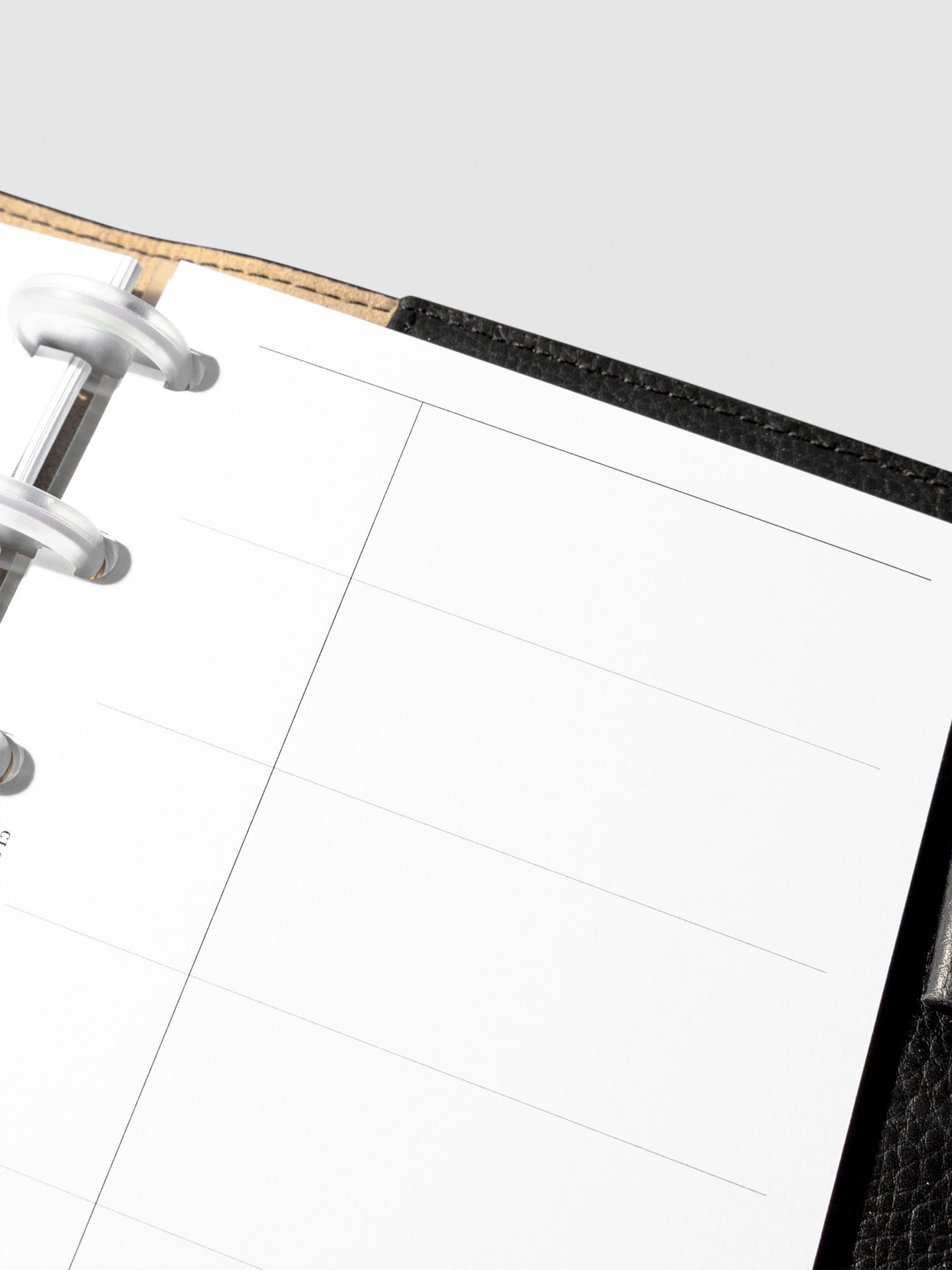 Set of inserts displayed inside a black leather planner.