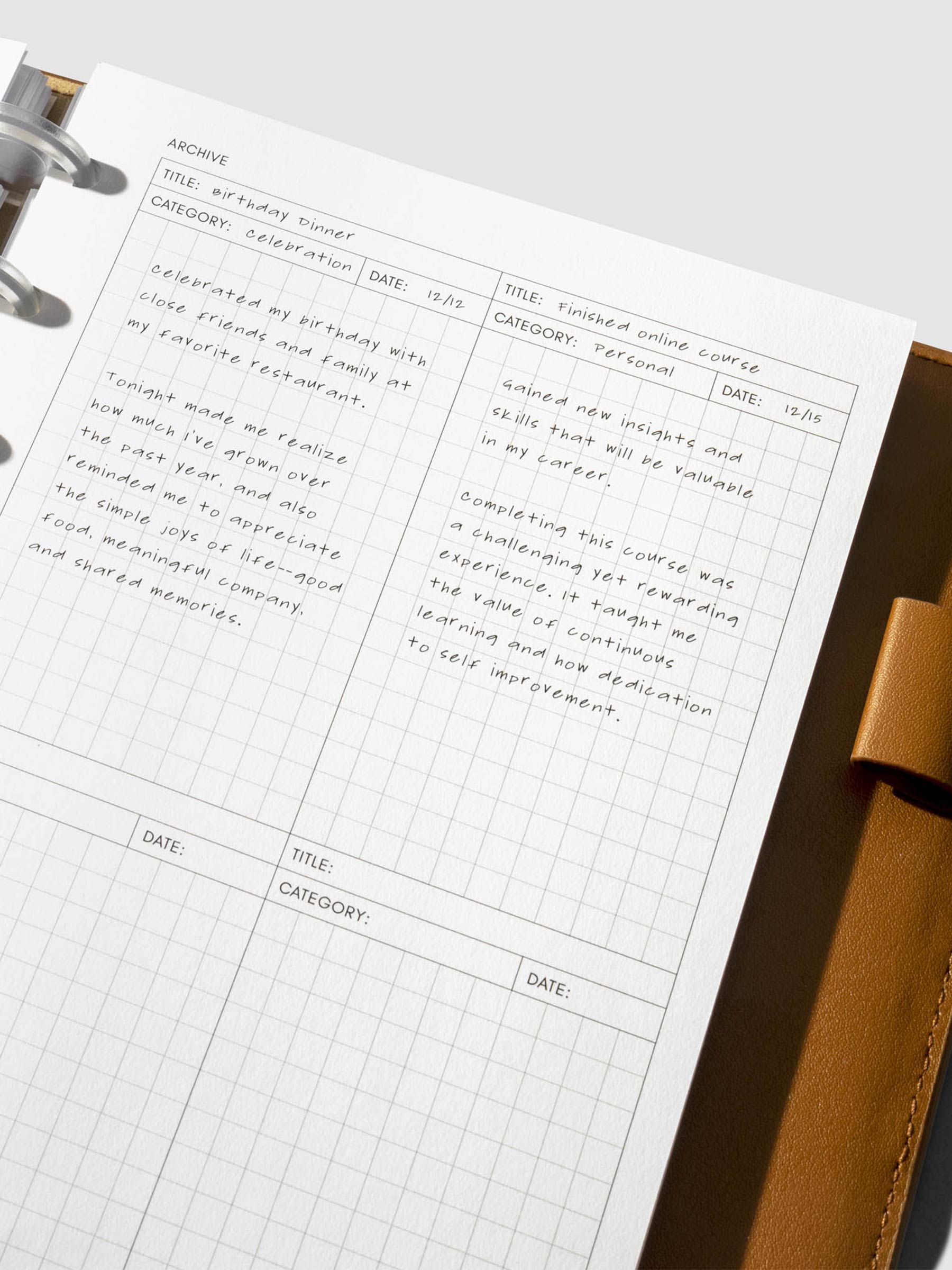 Closeup of inserts in use inside a leather planner.