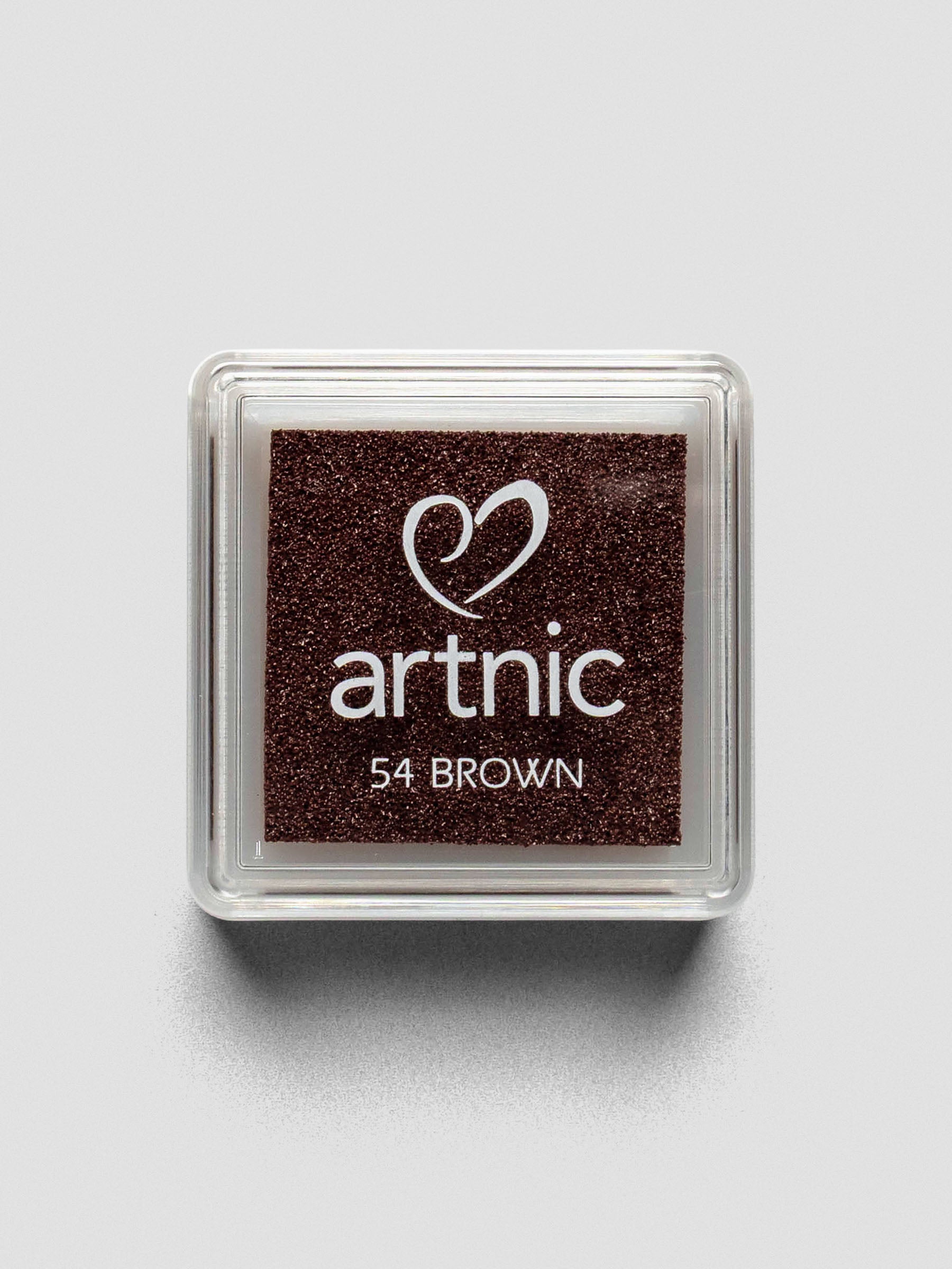 Top-down view of a closed Artnic stamp ink pad in brown, with the color name and logo printed on the clear lid.