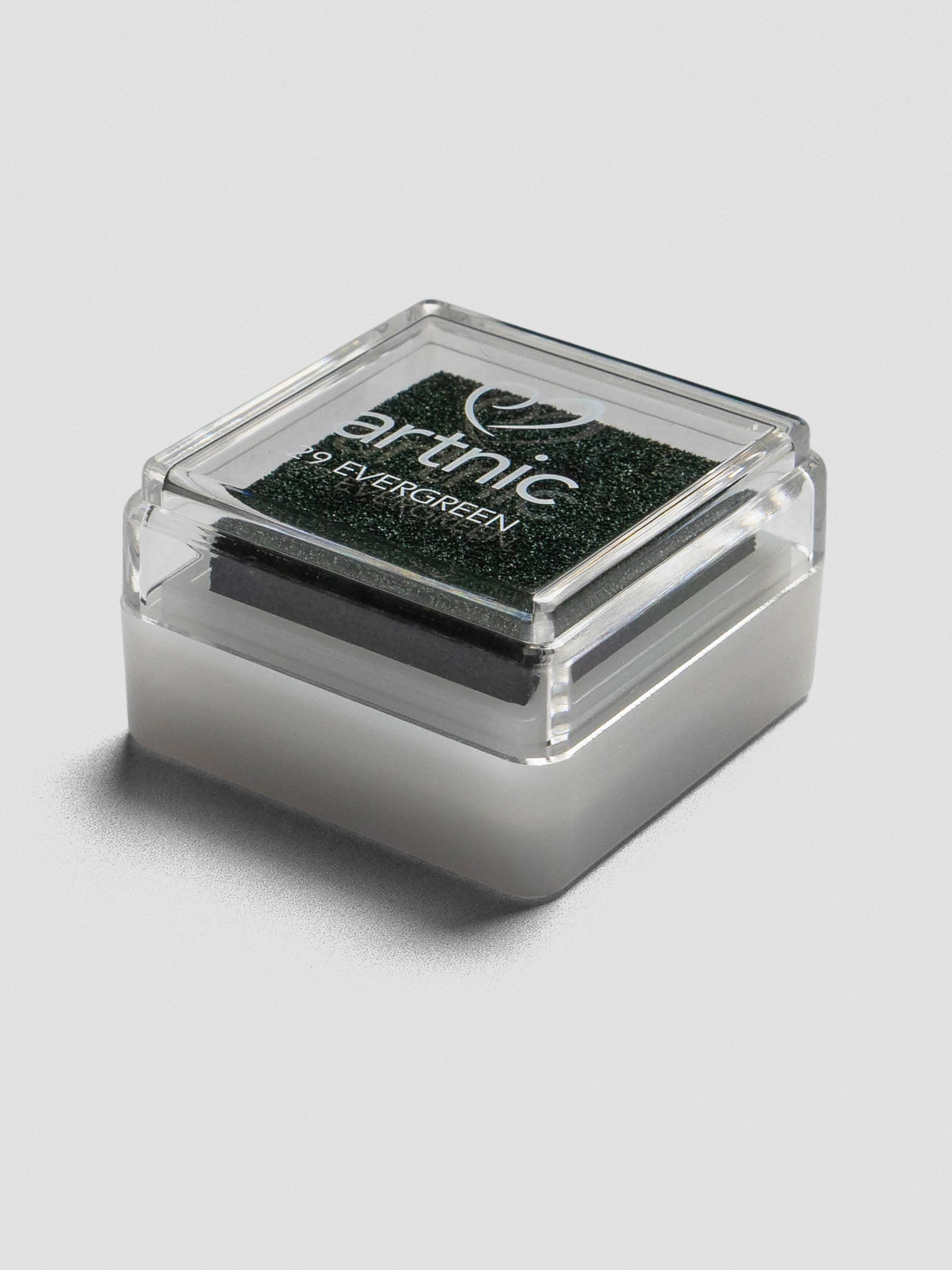 Angled view of Artnic Evergreen ink pad showing clear lid, black foam pad, and stackable white plastic base.