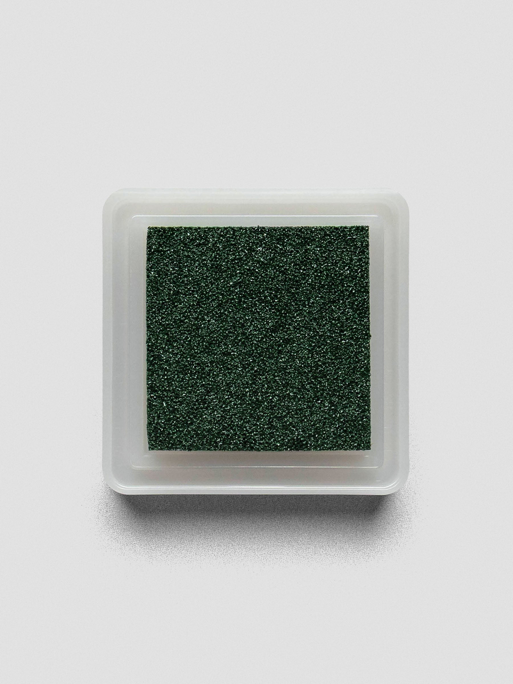 Top-down view of open Evergreen ink pad showing textured deep green surface.