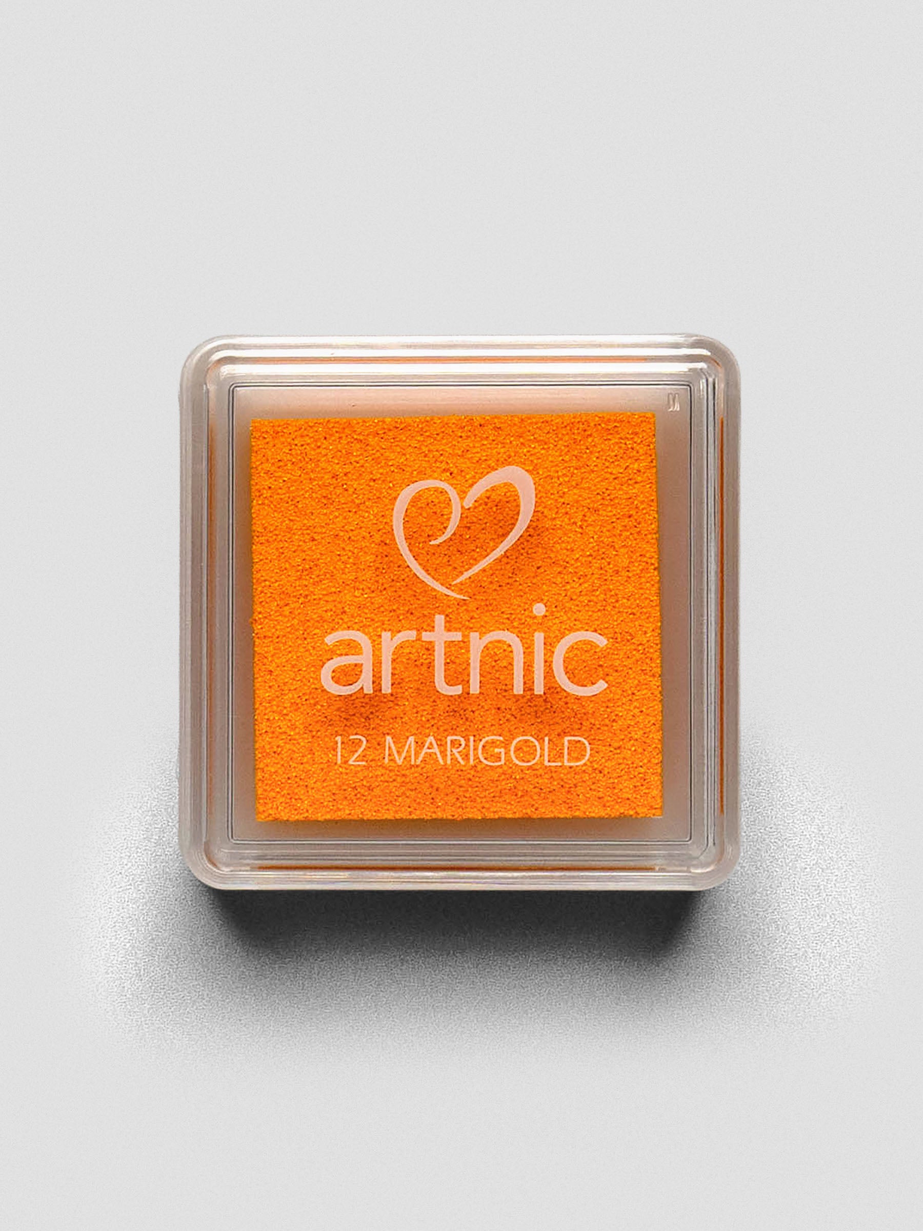 Square Artnic stamp ink pad in bright orange color labeled “12 Marigold,” with clear lid and white logo.