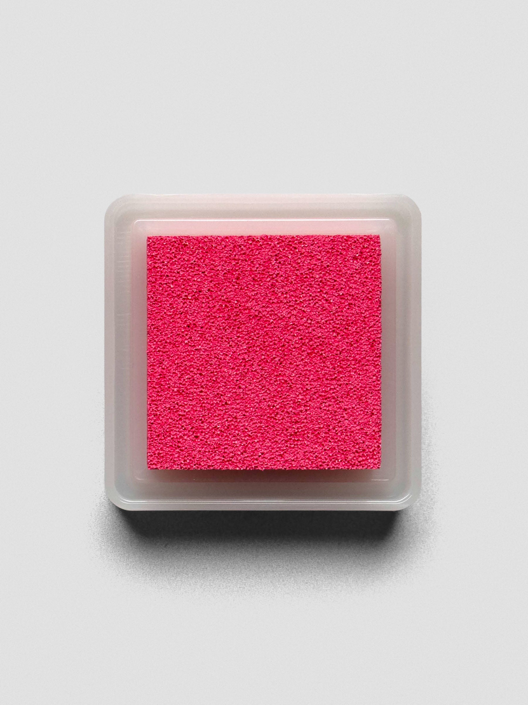 Pink Artnic ink pad without lid, top-down view showing textured ink surface.