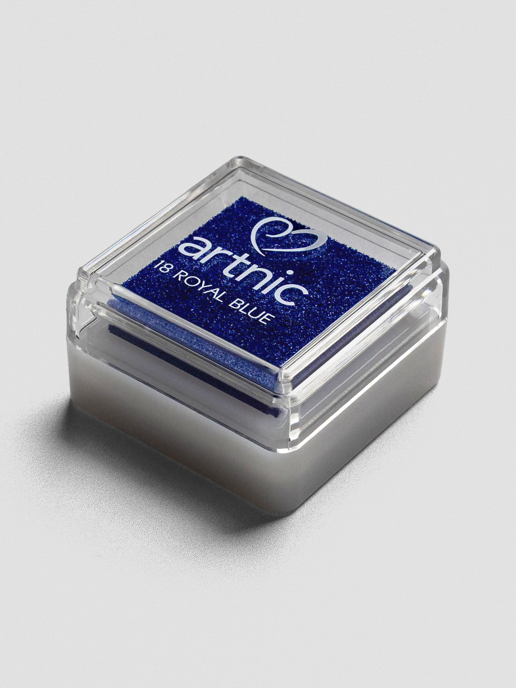 Blue Artnic ink pad with clear lid, angled view showing its stackable design.