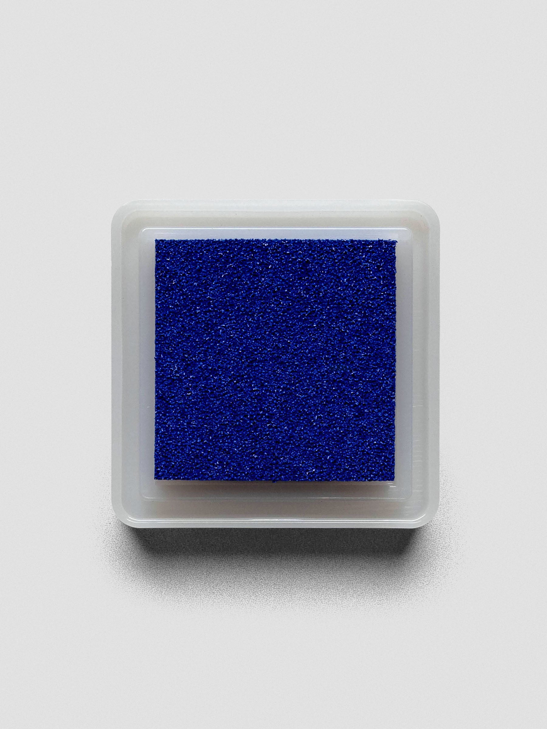 Blue Artnic ink pad without lid, top-down view showing textured ink surface.