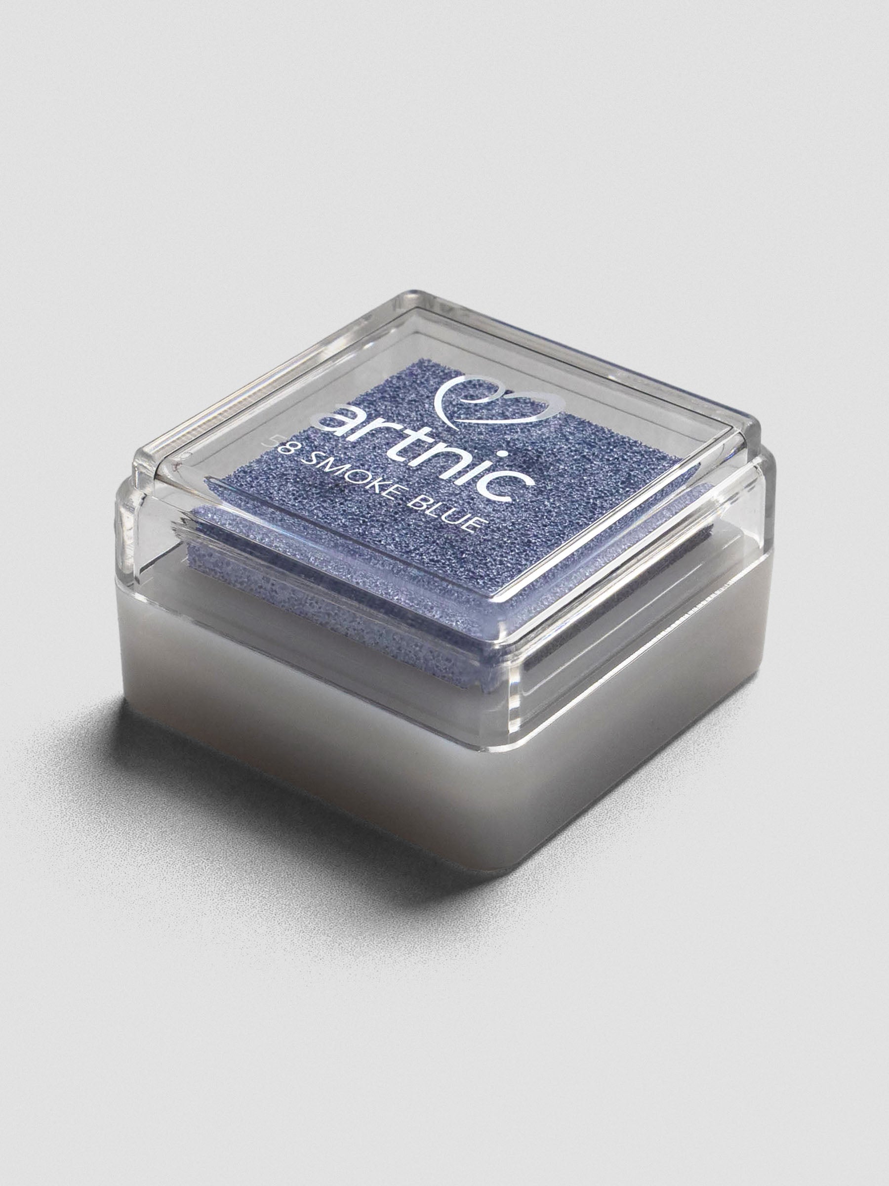 Light blue Artnic ink pad with clear lid, angled view showing its stackable design.