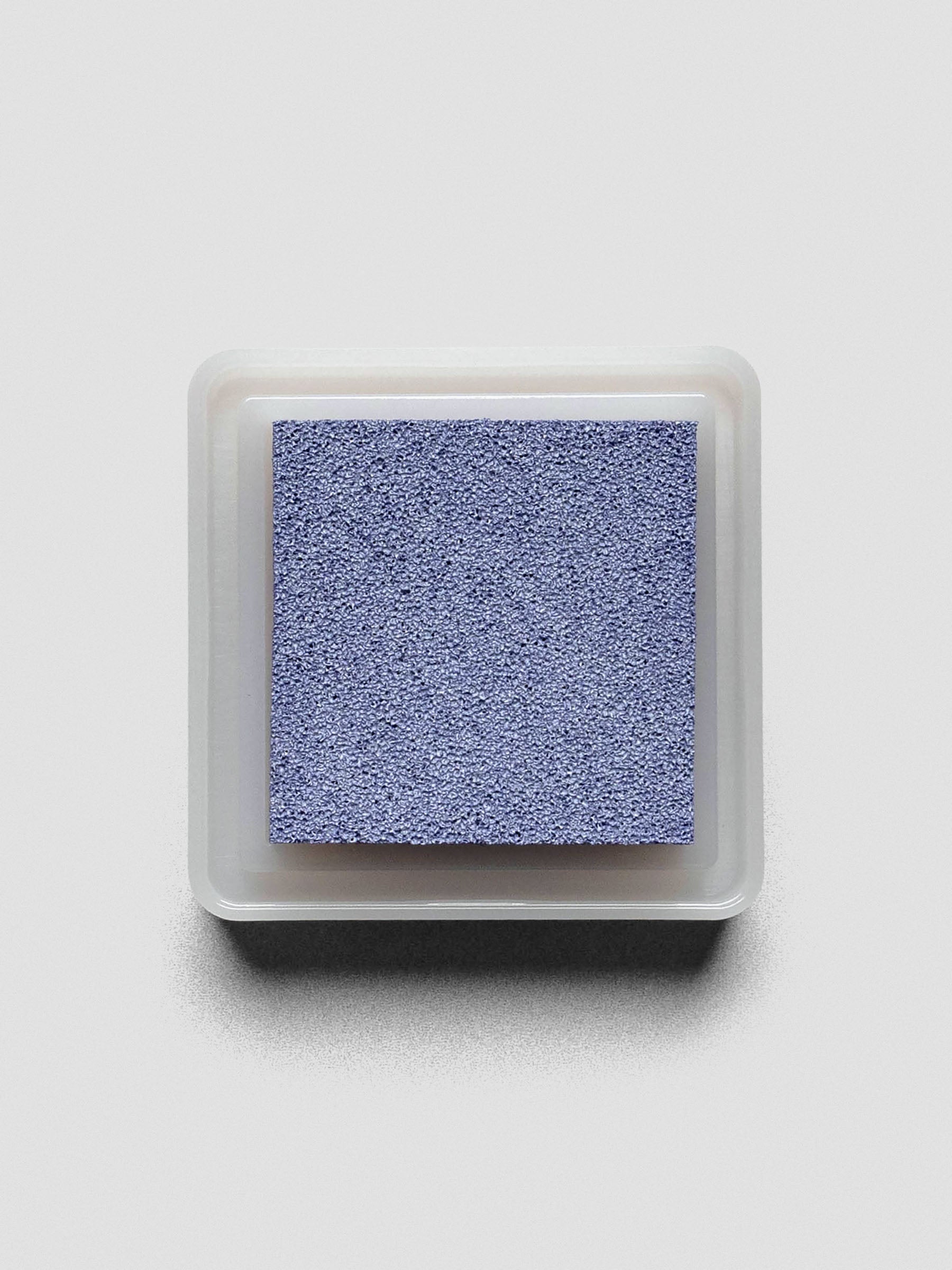 Light blue Artnic ink pad without lid, top-down view showing textured ink surface.