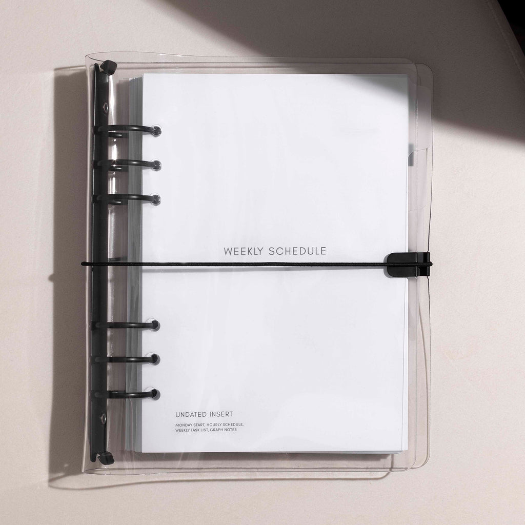 Beginner Planner Bundle in A5, assembled in the Clear Vinyl Cover, resting on a white background with shadows.
