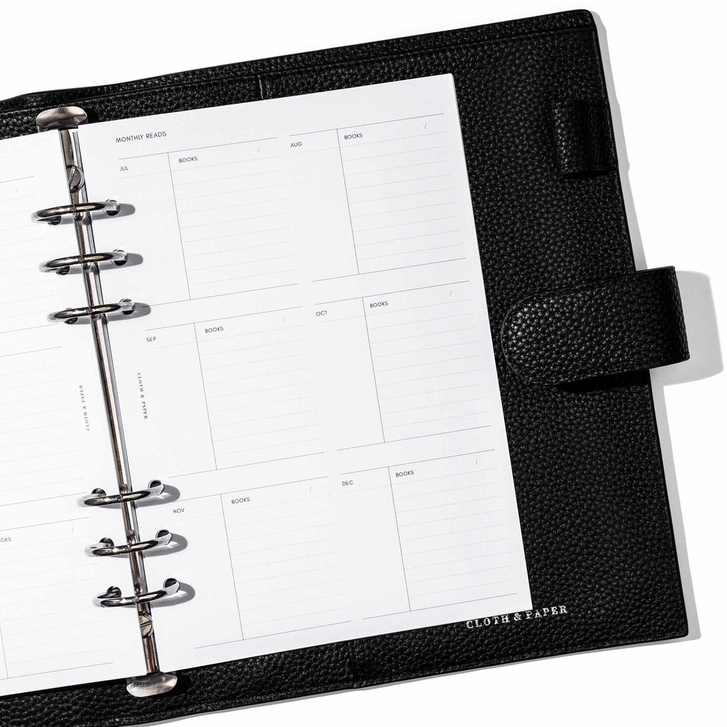 Insert in use inside a black leather planner. Page shown is the monthly reads section.