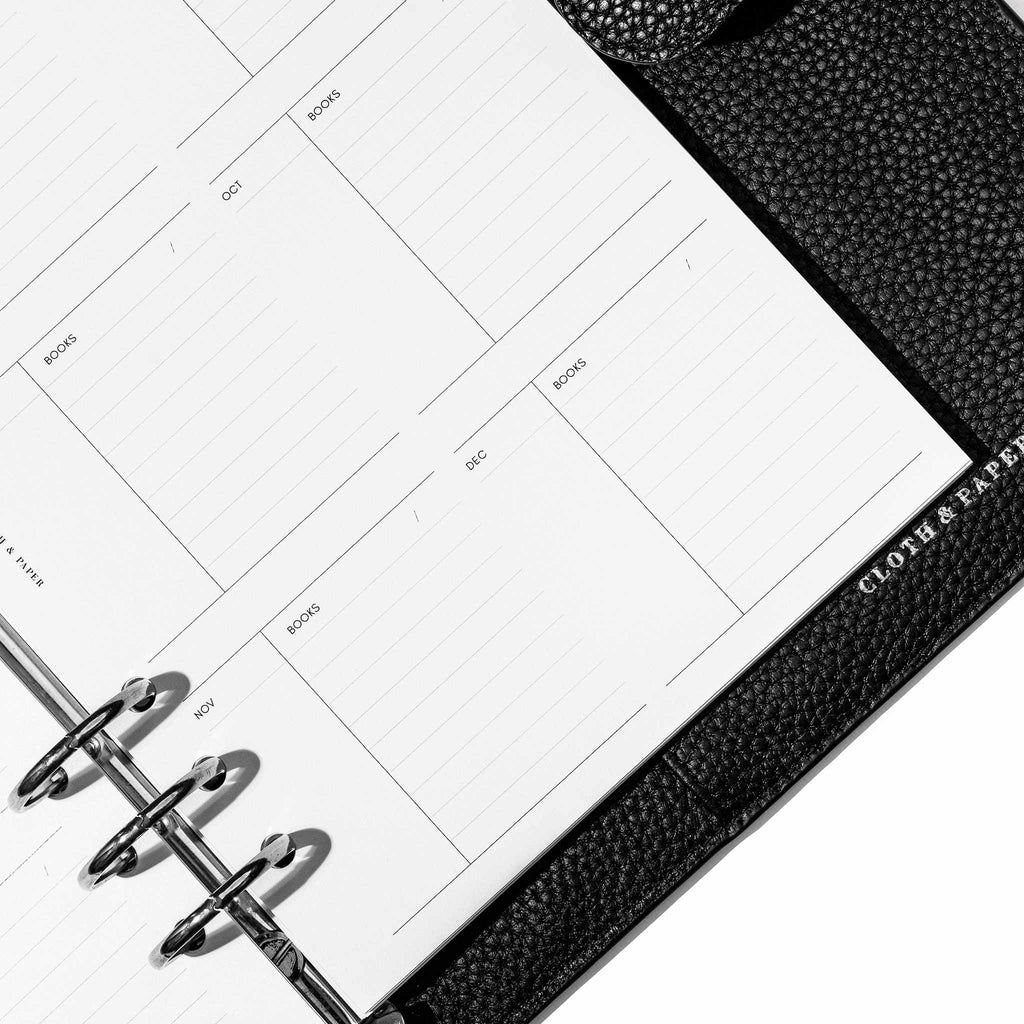 Insert in use inside a black leather planner. Page shown is the monthly reads section.