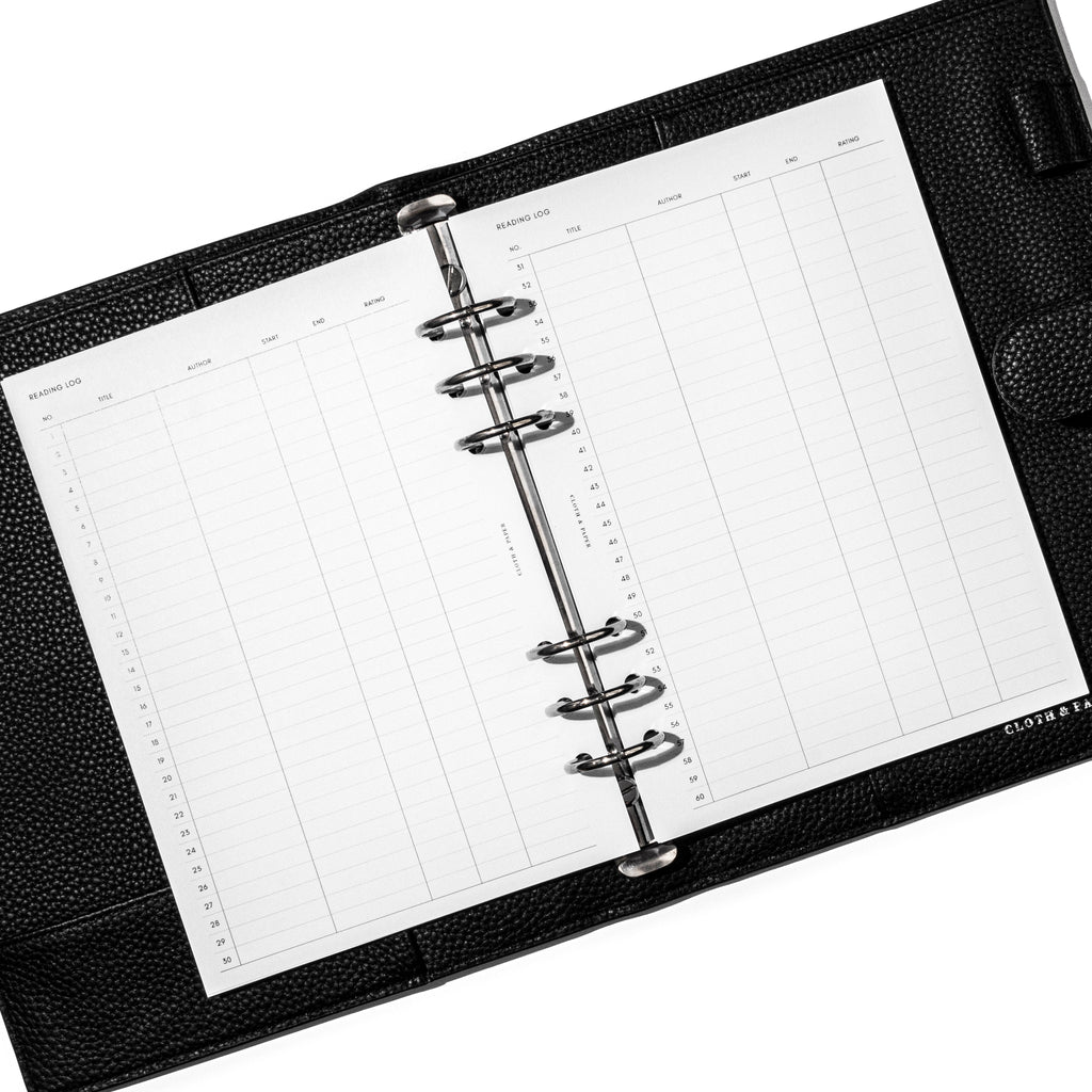 Bibliophile Planner Inserts in use inside a 6-ring black leather planner on a white background. The reading log spread is displayed.