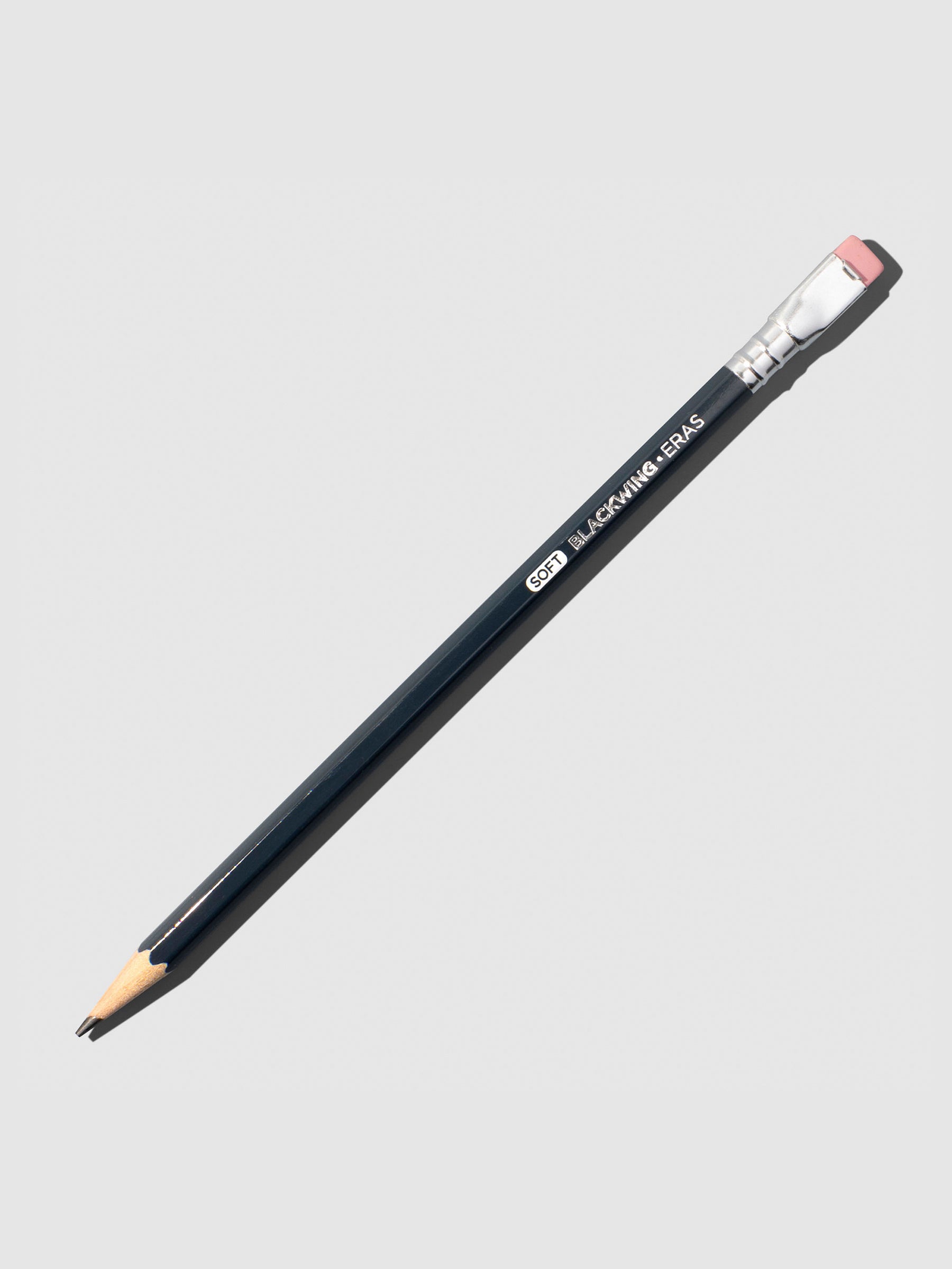 Dark grey wooden pencil displayed on a neutral background.