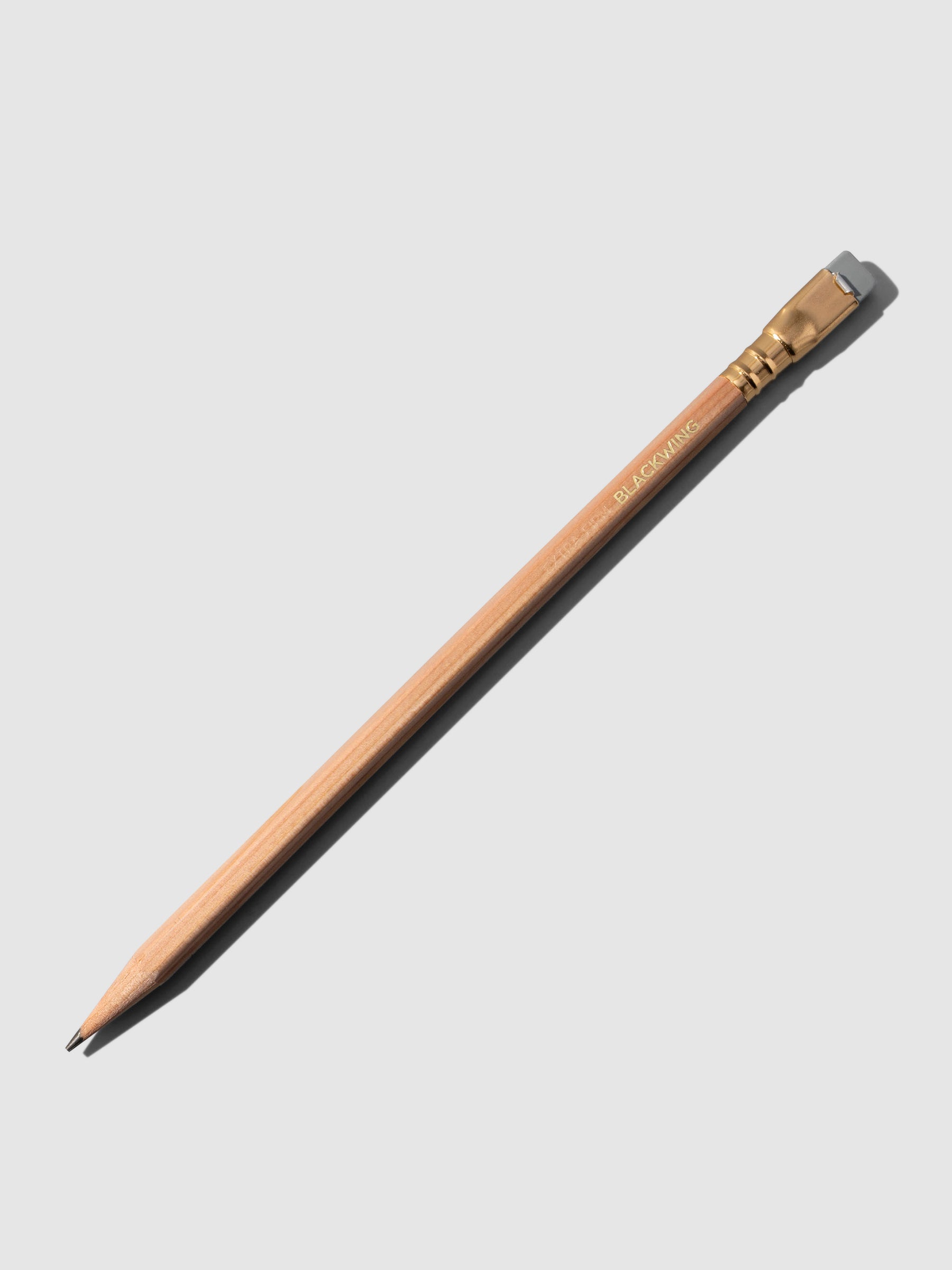 Brown wooden pencil displayed on a neutral background.