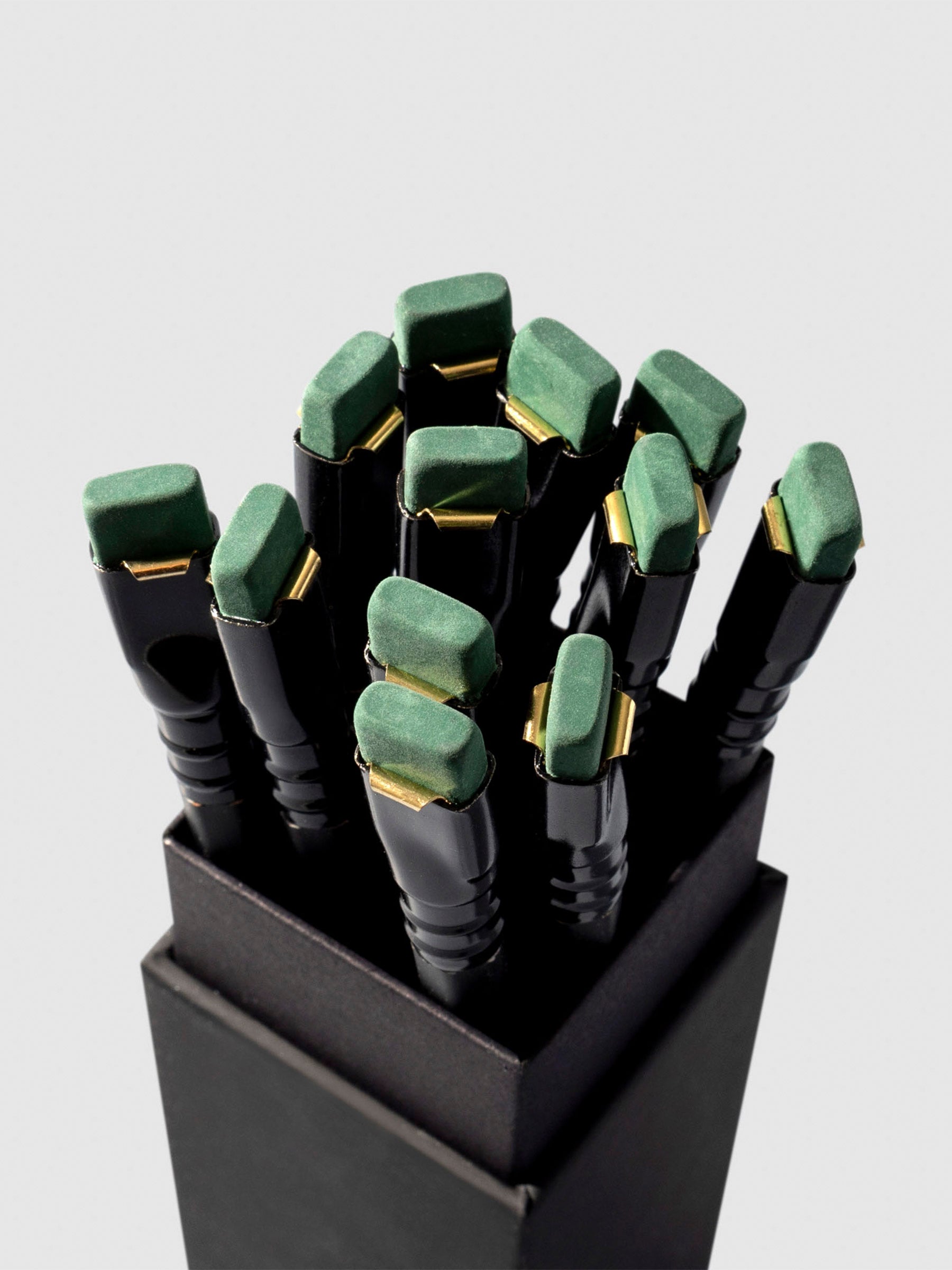 Set of 12 pencils displayed eraser side up inside the pencil packaging.