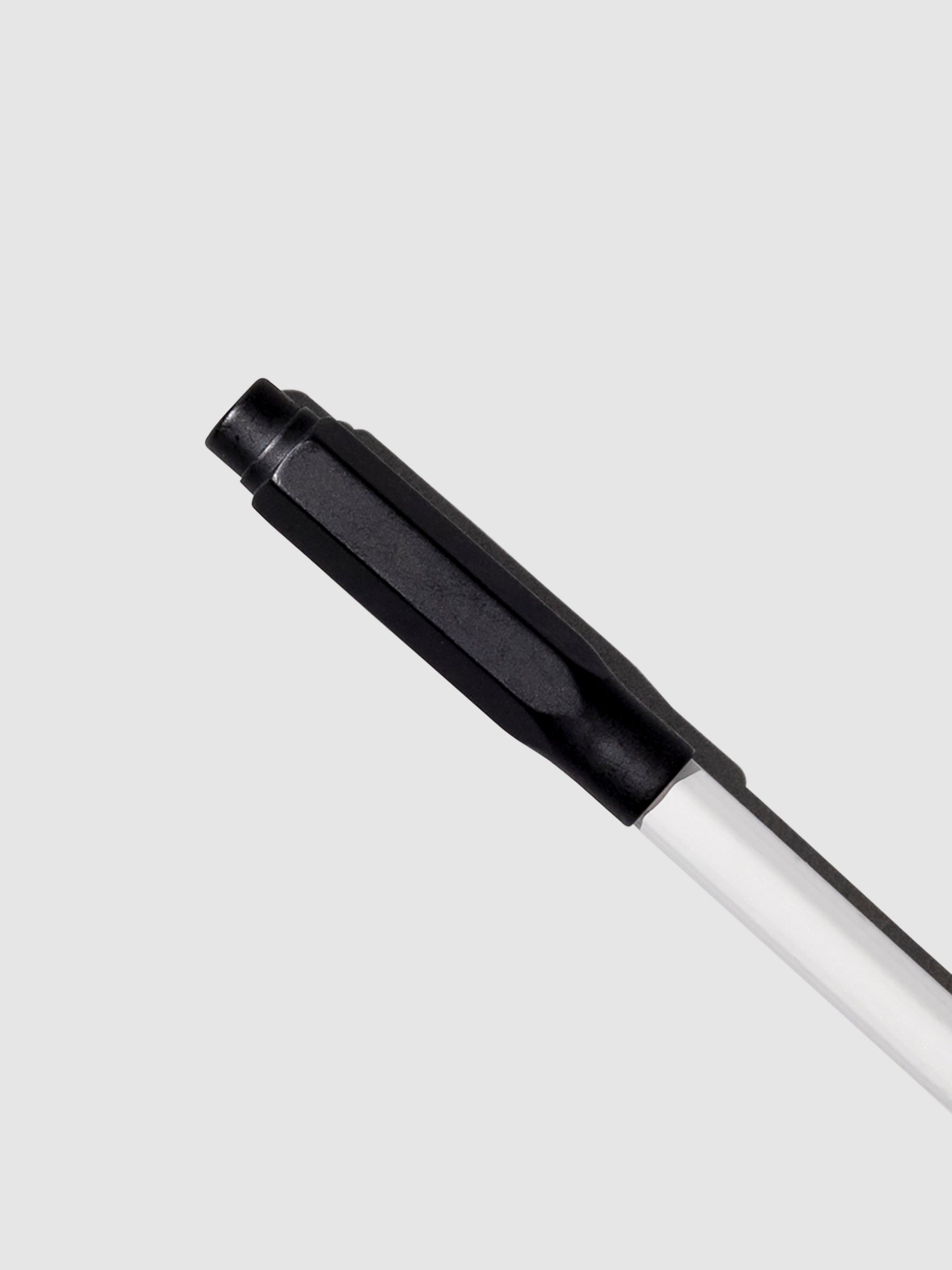 The image shows the blackwing point guard in matte black covering the sharpened tip of a white pencil.