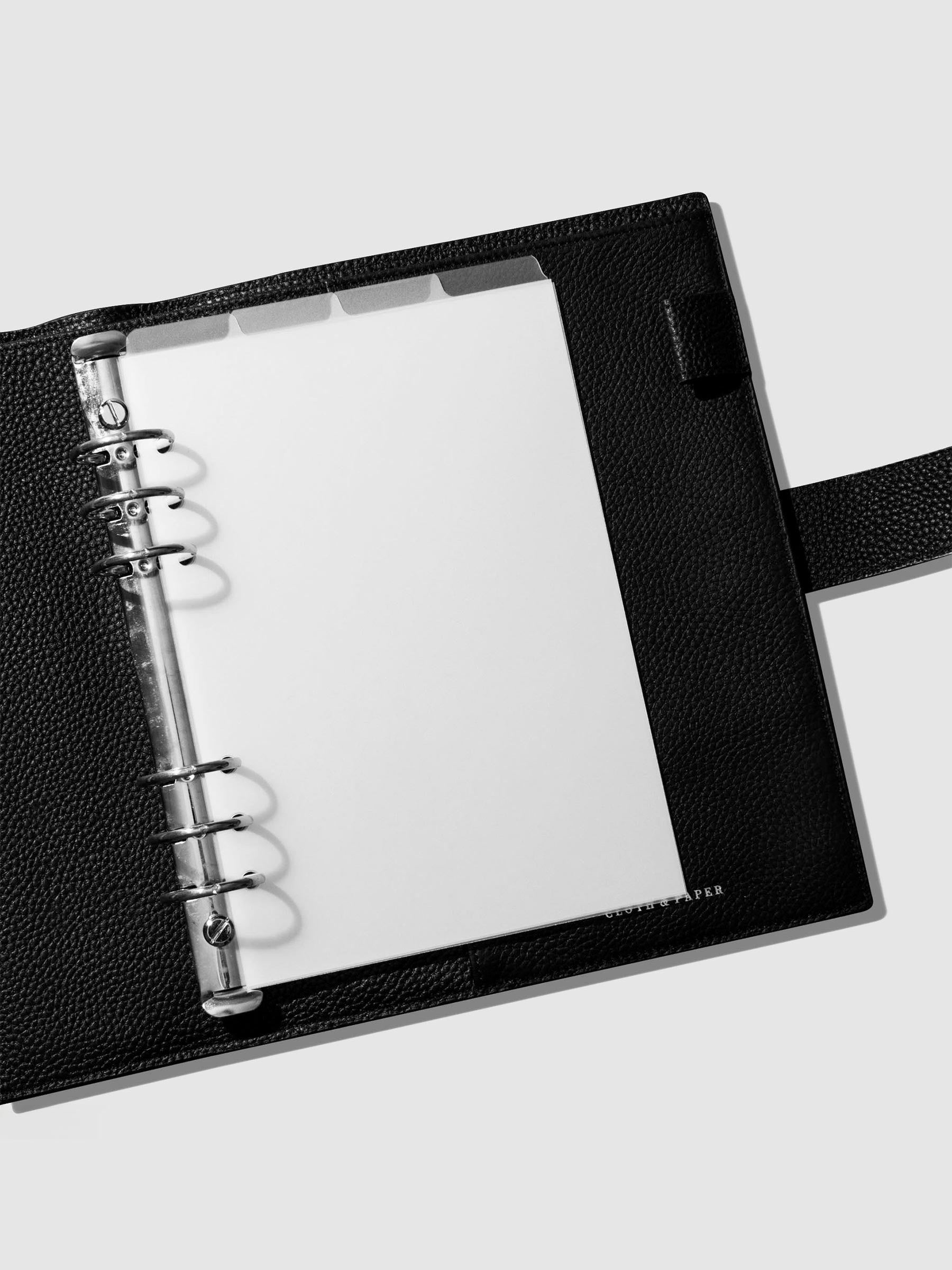 Dividers in use inside a black leather agenda.