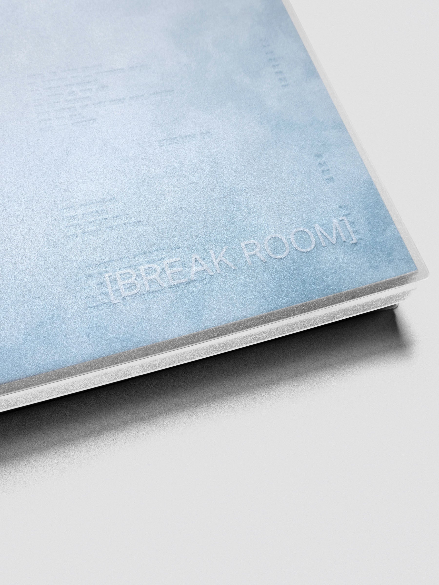 A close up of the velvet blue top spiral notebook with text design reading "Break Room".
