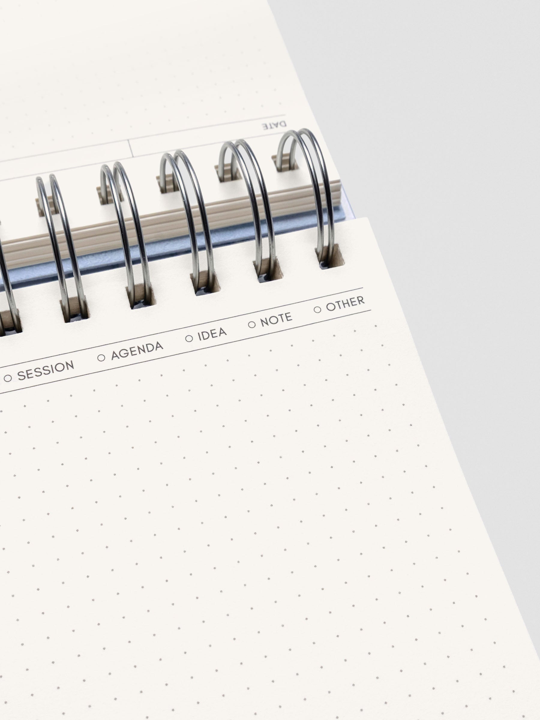 Close up of the open notebook showing header options reading "Session, Agenda, Idea, Note, and Other".