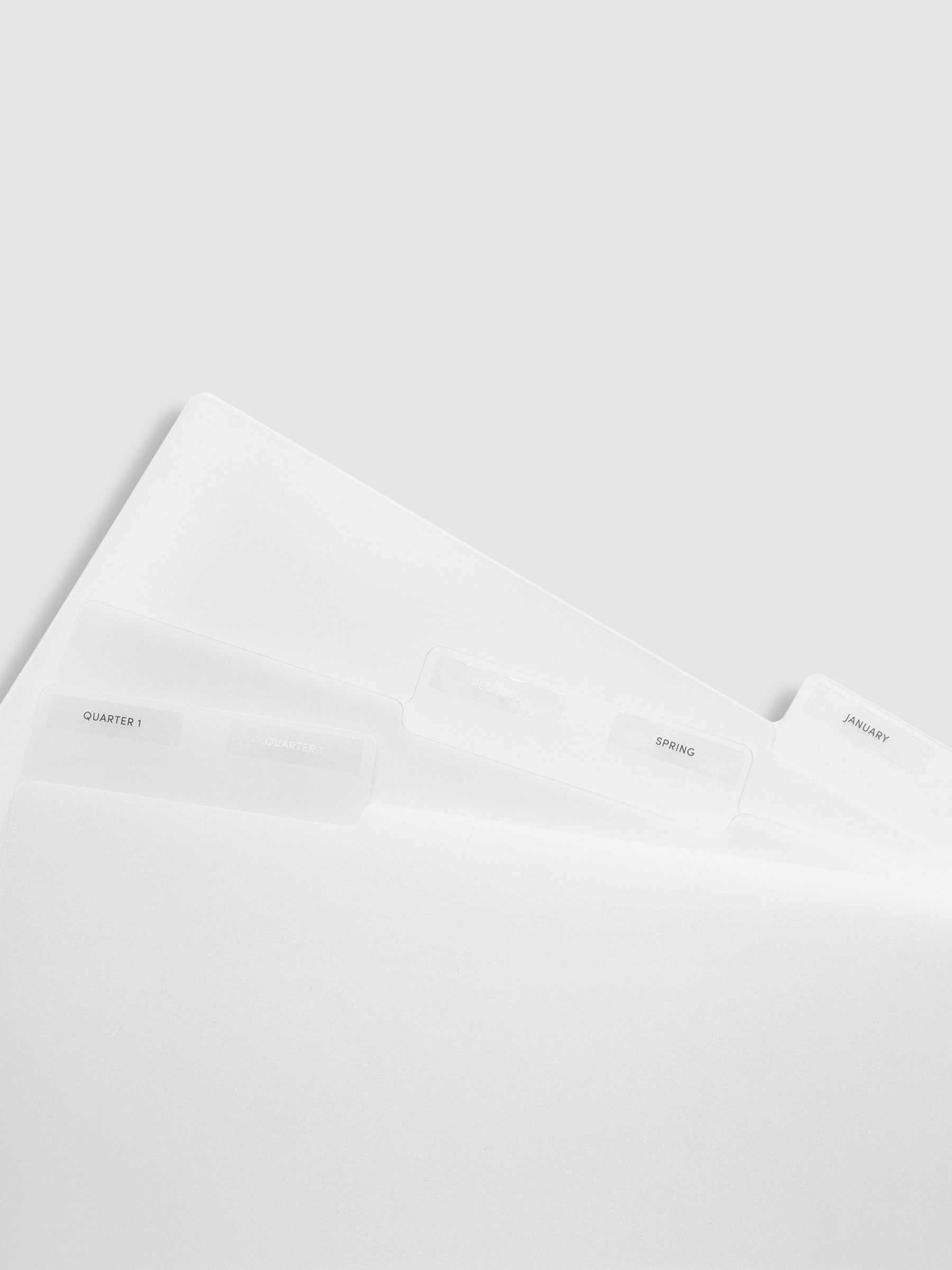 3 folders layered on top of each other. Labels are attached to them, reading "January", "Spring", and "Quarter 1."