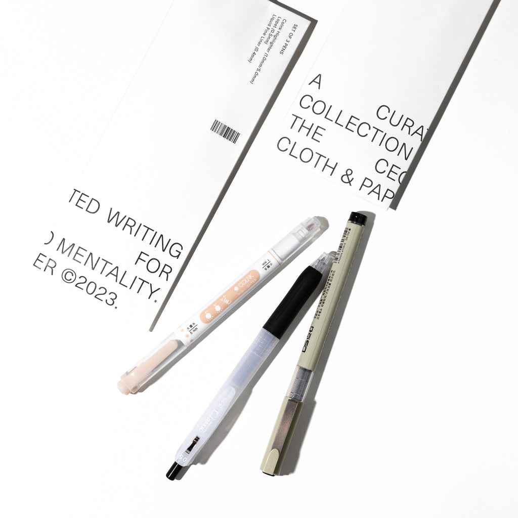 CEO Writing Collection, Cloth and Paper. Two pens, a highlighter, and the product packaging are displayed on a white background.