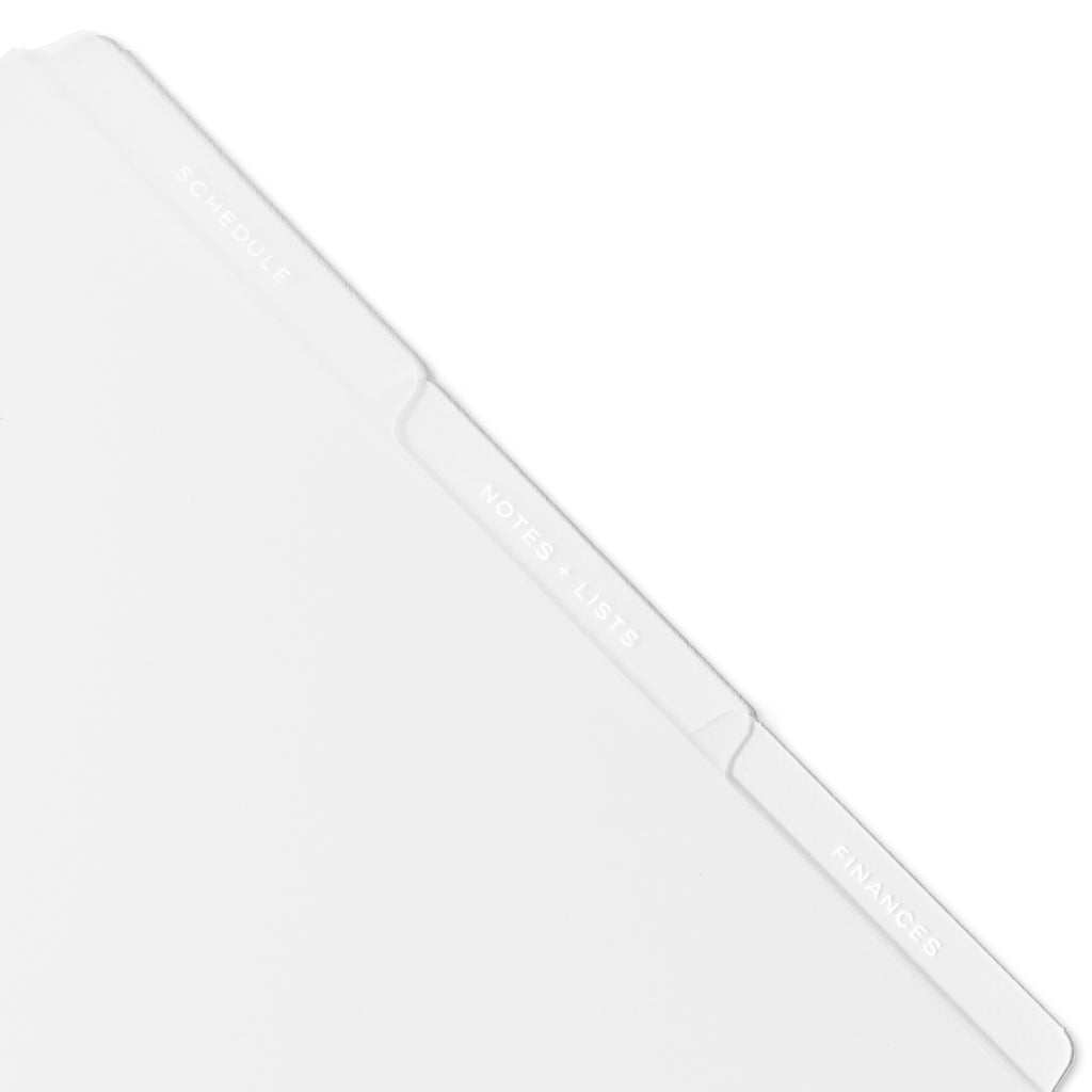 Closeup of white tab dividers displayed on a white background.