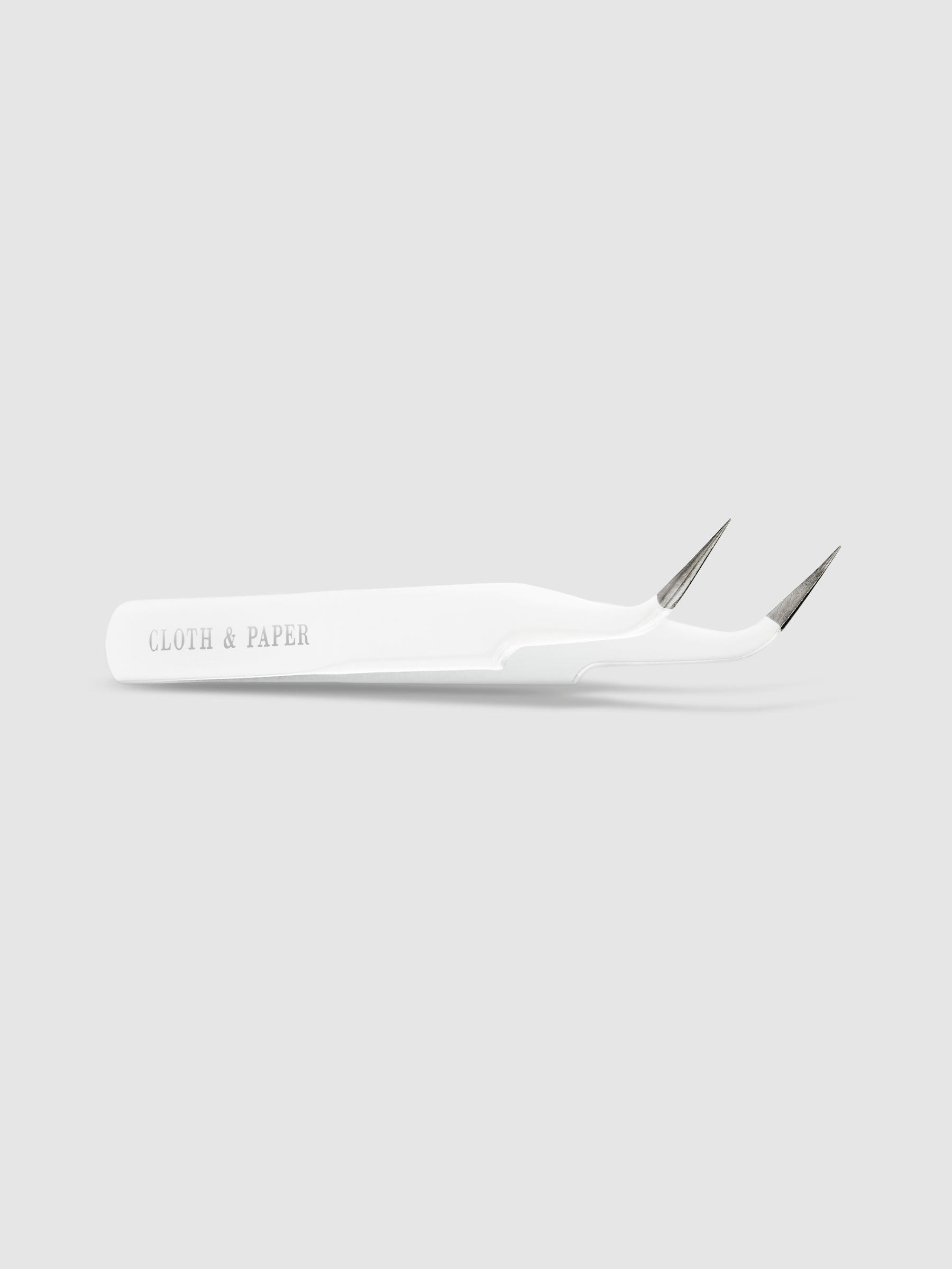 White tweezers displayed on a neutral background.
