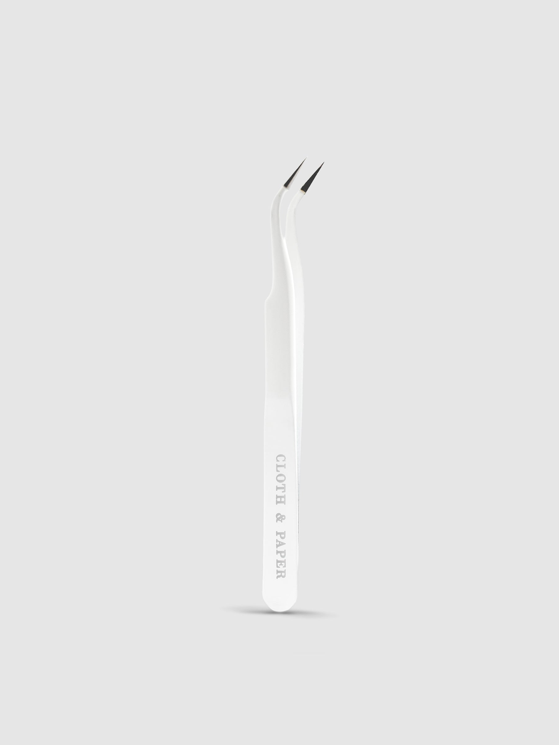 White tweezers displayed on a neutral background.