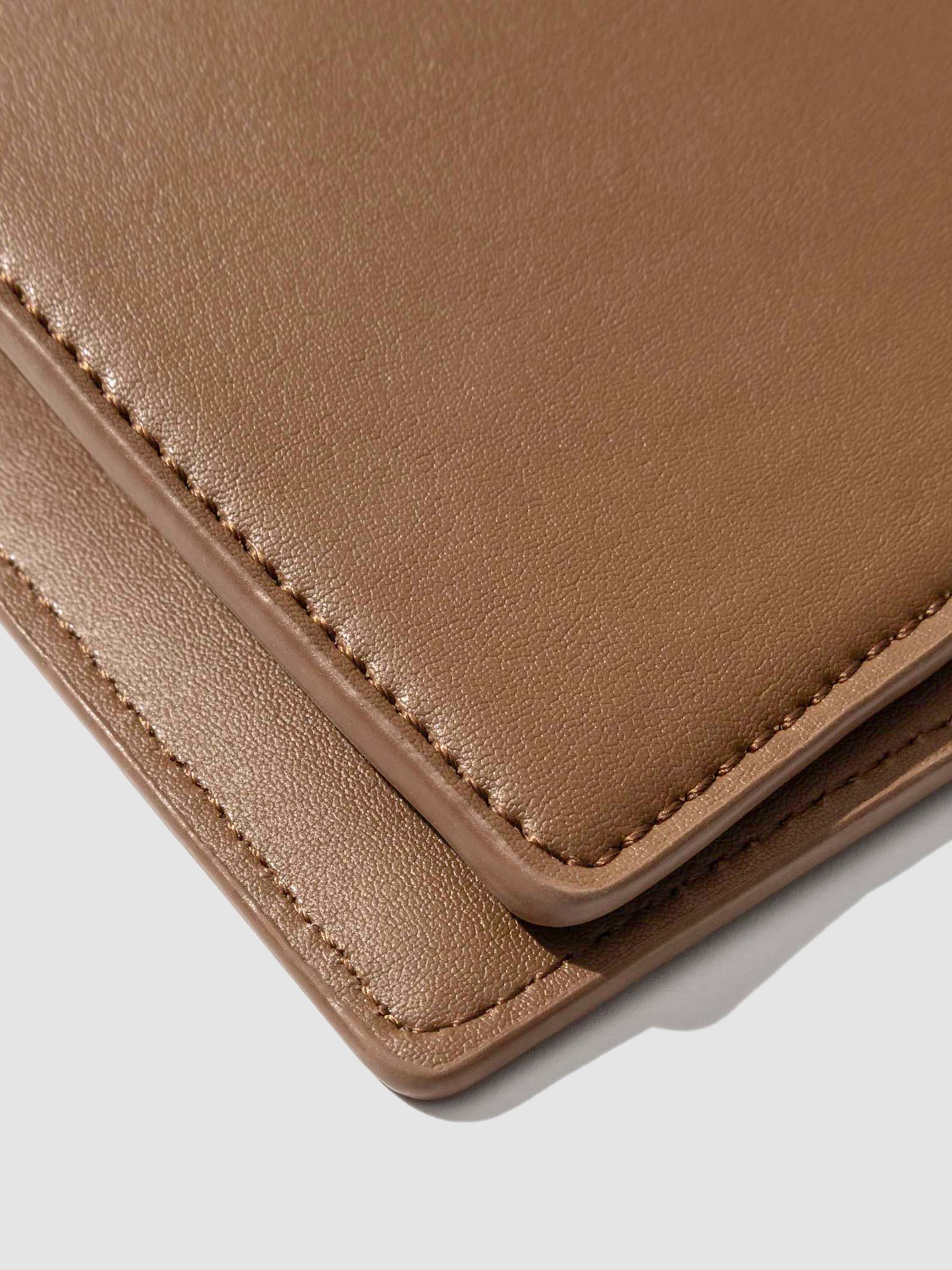 Closeup of clay brown folio's smooth vegan leather.