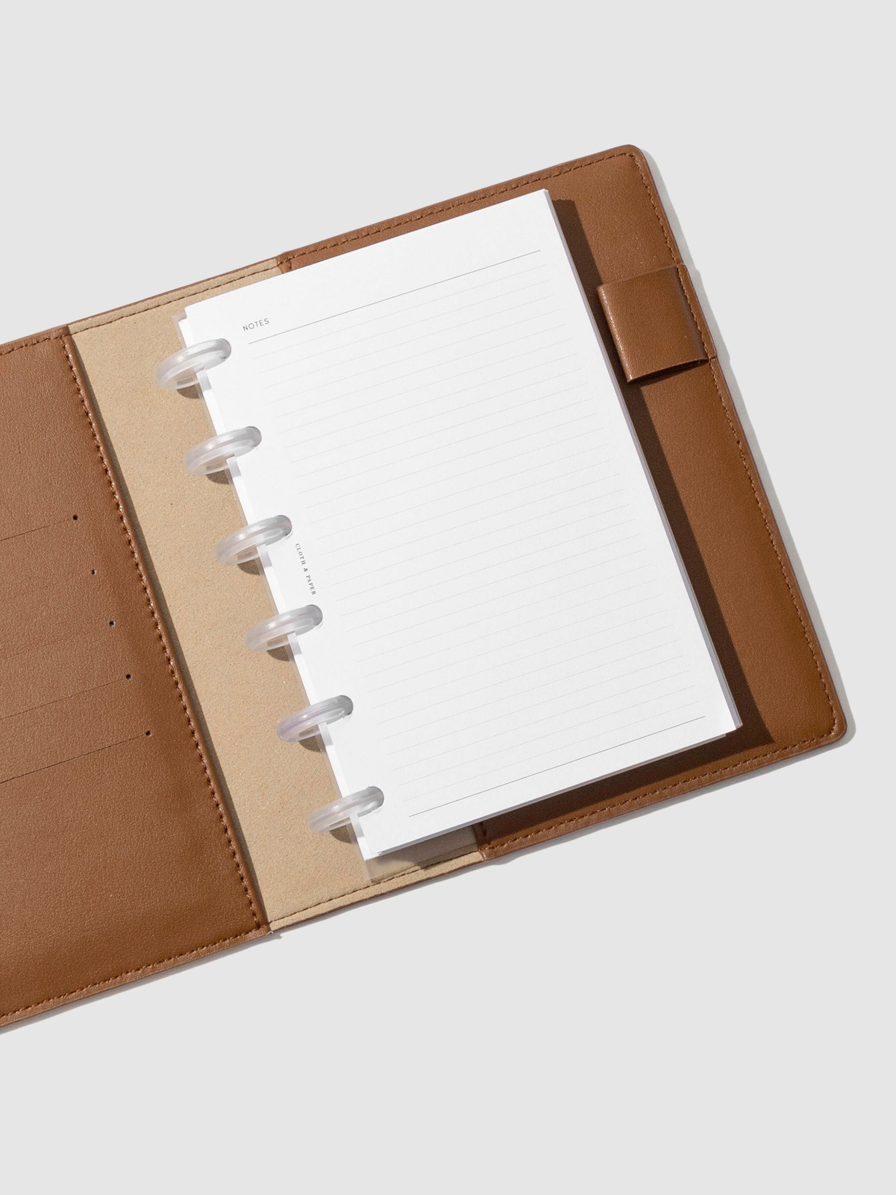 CP Petite folio displayed opened on a neutral background. Color shown is clay brown. 