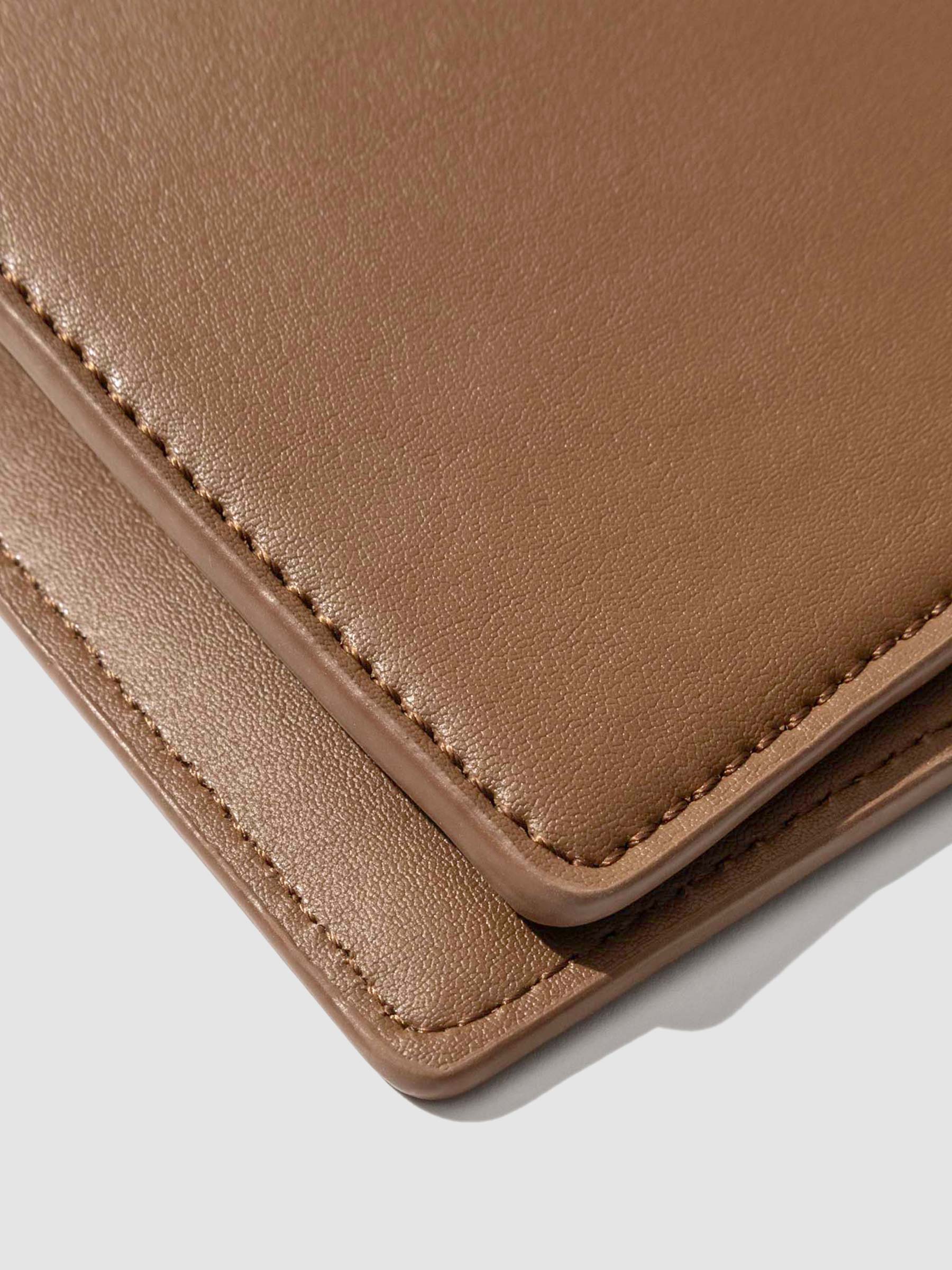 Closeup of clay brown folio's smooth vegan leather.