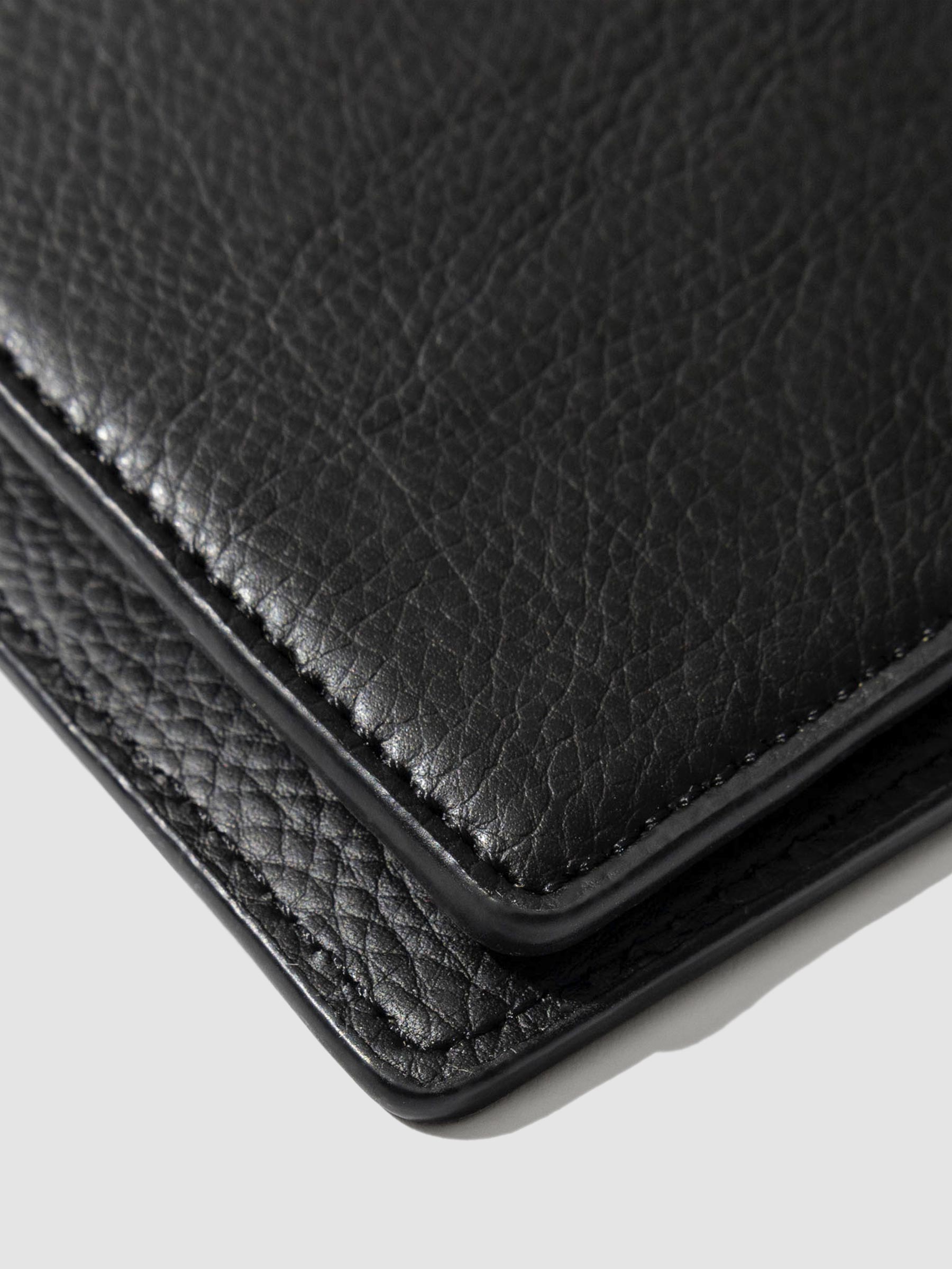 Closeup of mesa black folio's textured vegan leather.