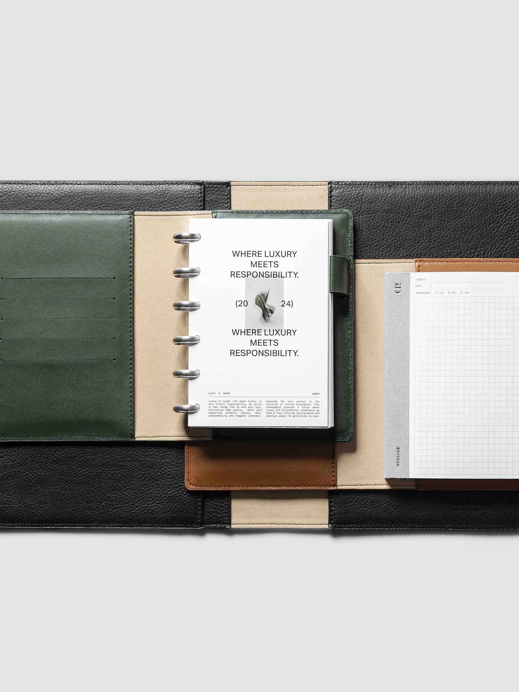 Collection of vegan leather folios displayed on a neutral background. A green folio is the centerpiece, displaying a Responsibility dashboard inside of it.